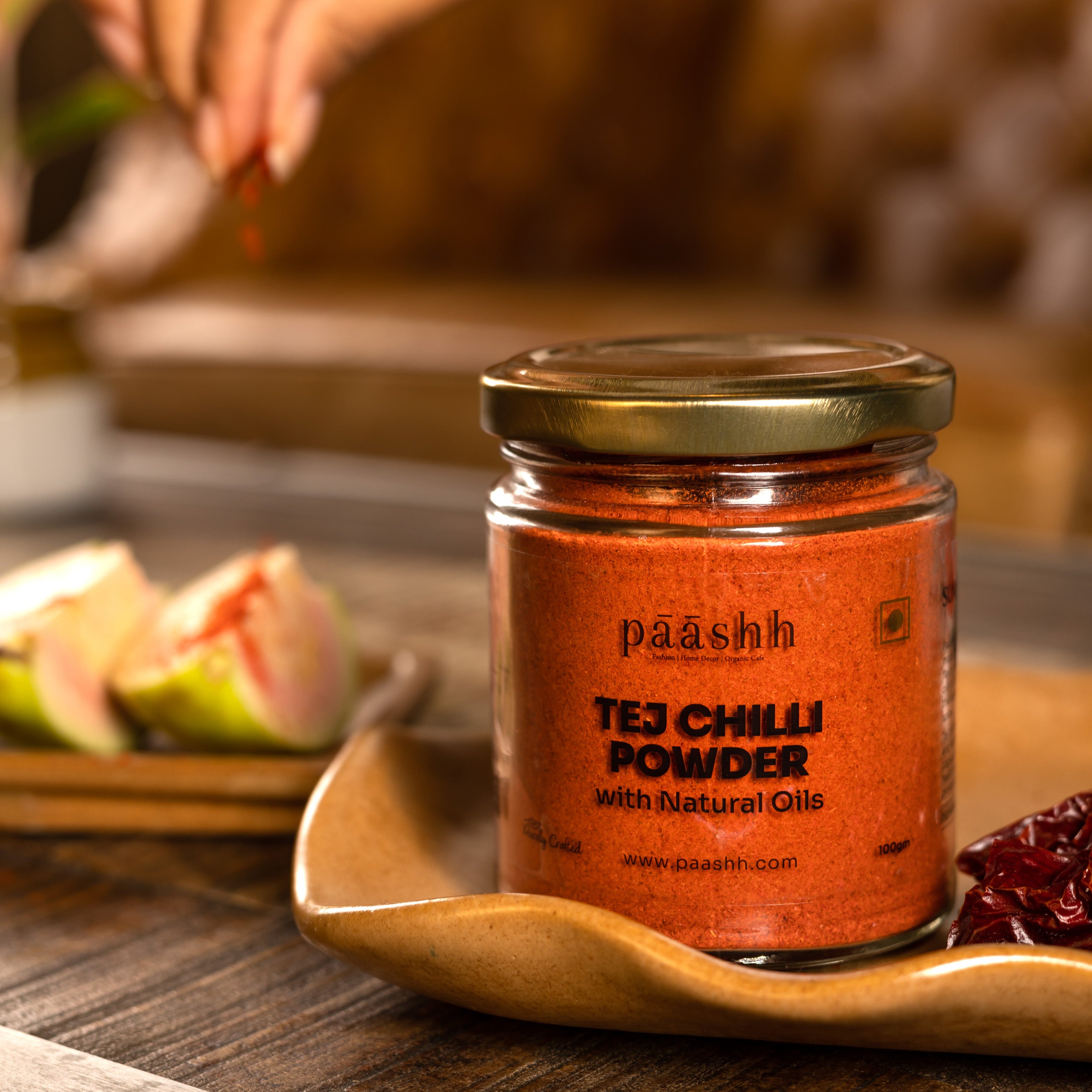 Jar of paashh Tej Chilli Powder on a wooden surface, organic spices India, organic kitchen ingredients