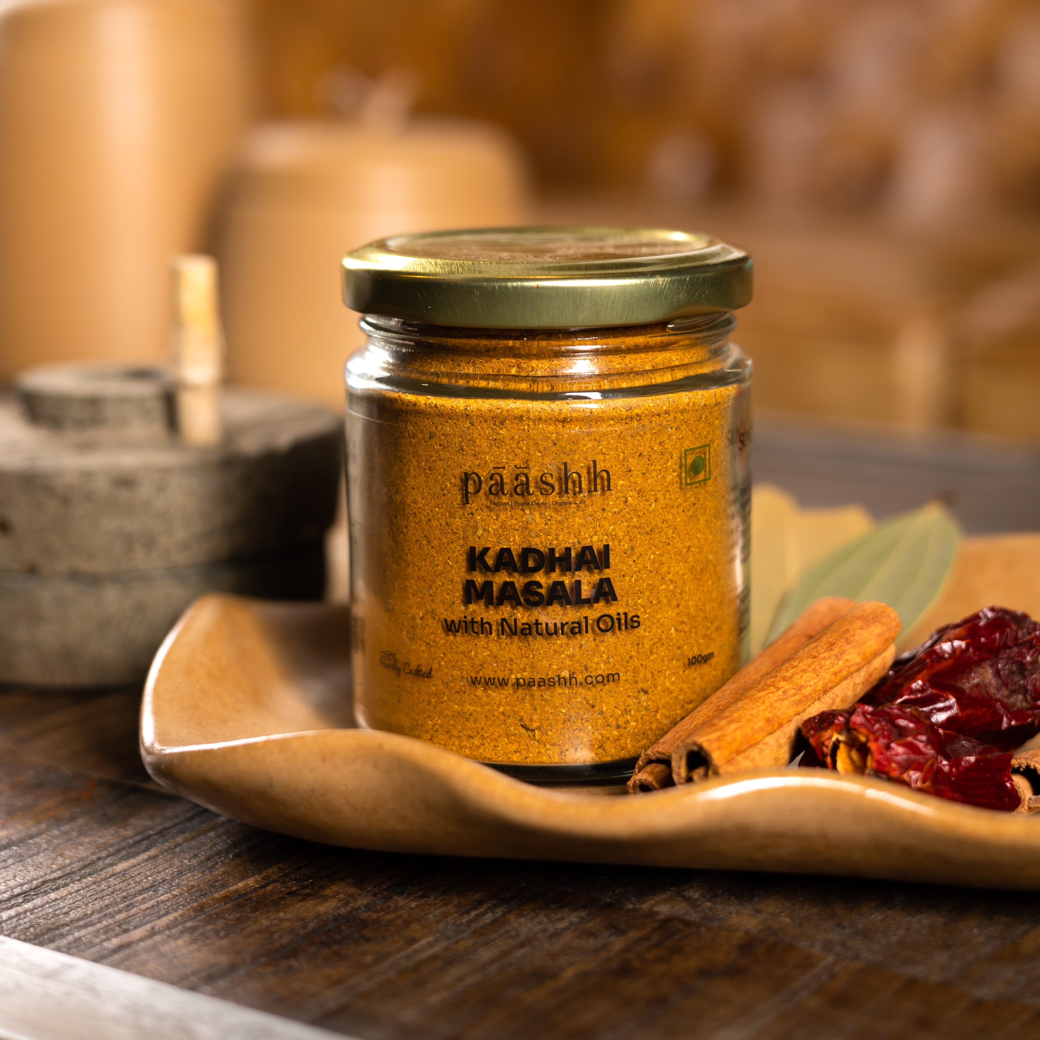 Jar of 'Paashh' Kadhai Masala on a wooden tray with spices in the background, handcrafted masala blends India, organic kitchen ingredients