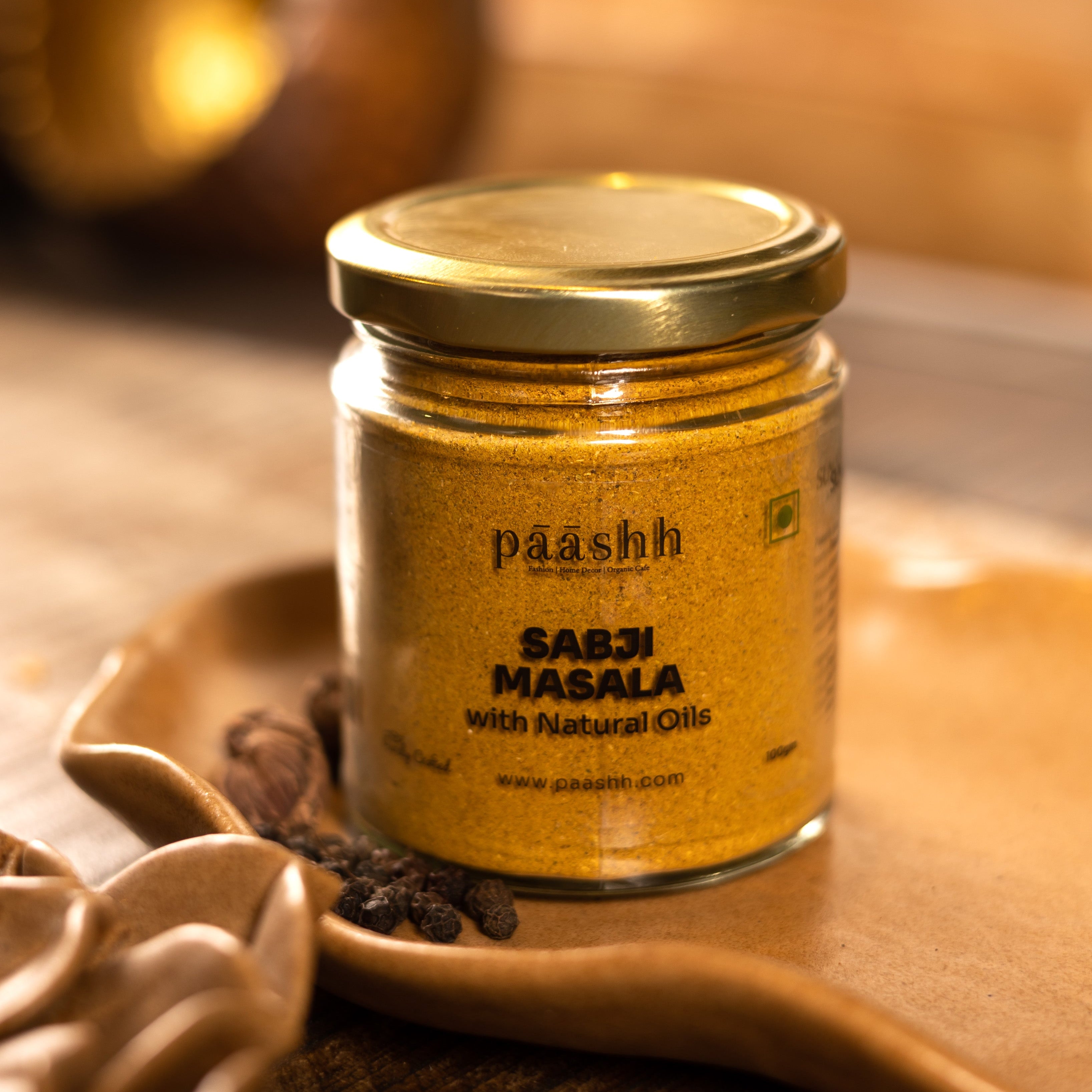 Jar of paashh Sabji Masala on a wooden surface, handcrafted masala blends India, organic kitchen ingredients