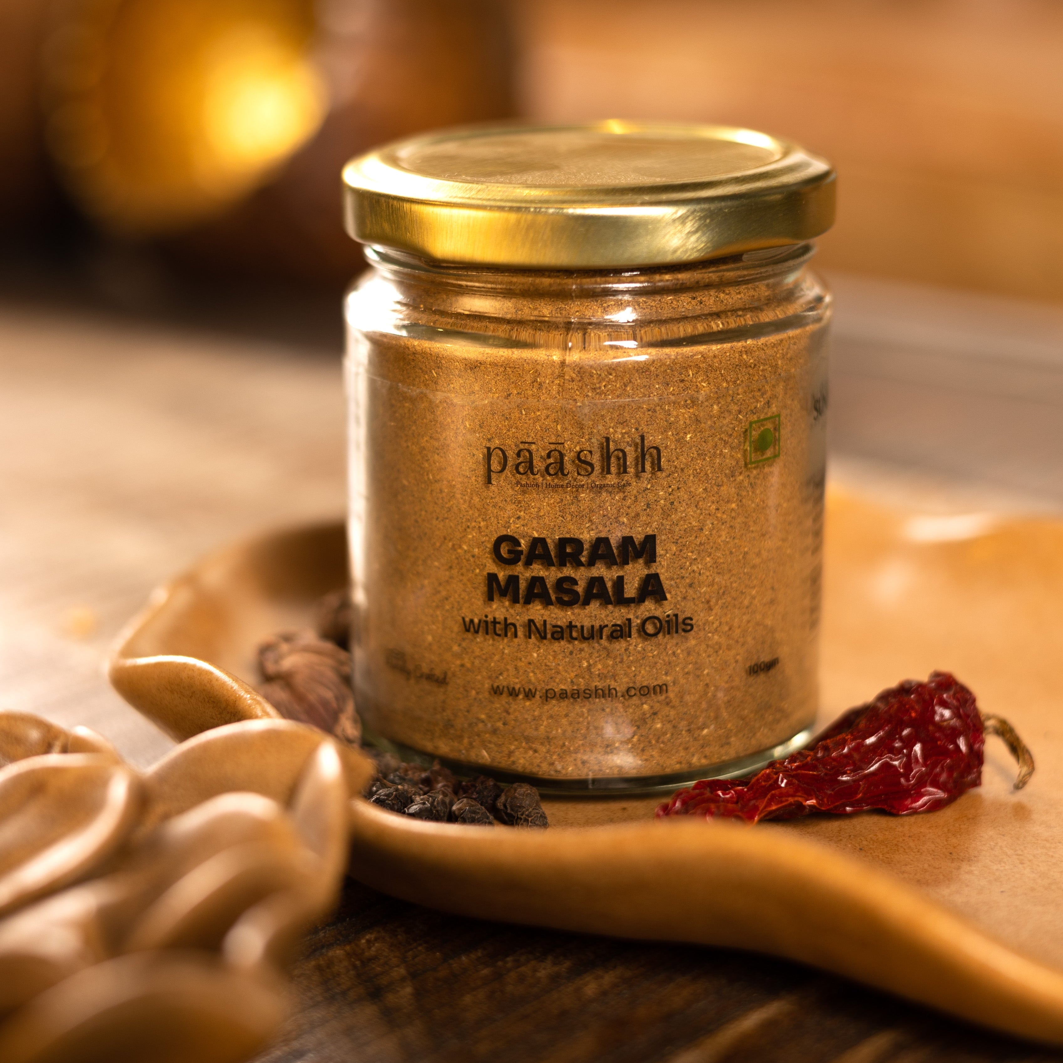 Jar of paashh Garam Masala on a wooden surface, handcrafted masala blends India, organic kitchen ingredients