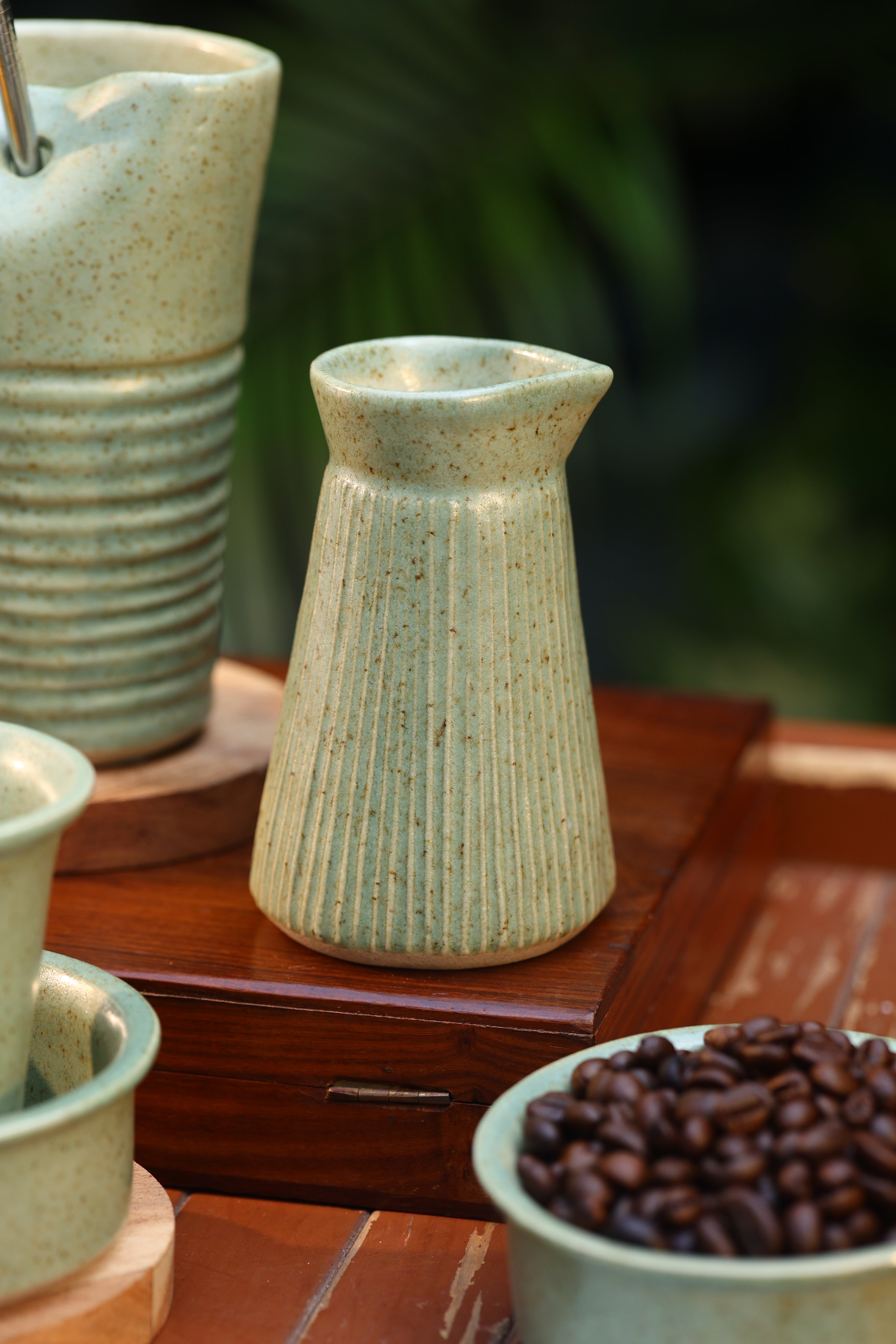 Close-up of ceramic containers with textured design on a wooden surface, ceramic tableware India, pottery brands in India