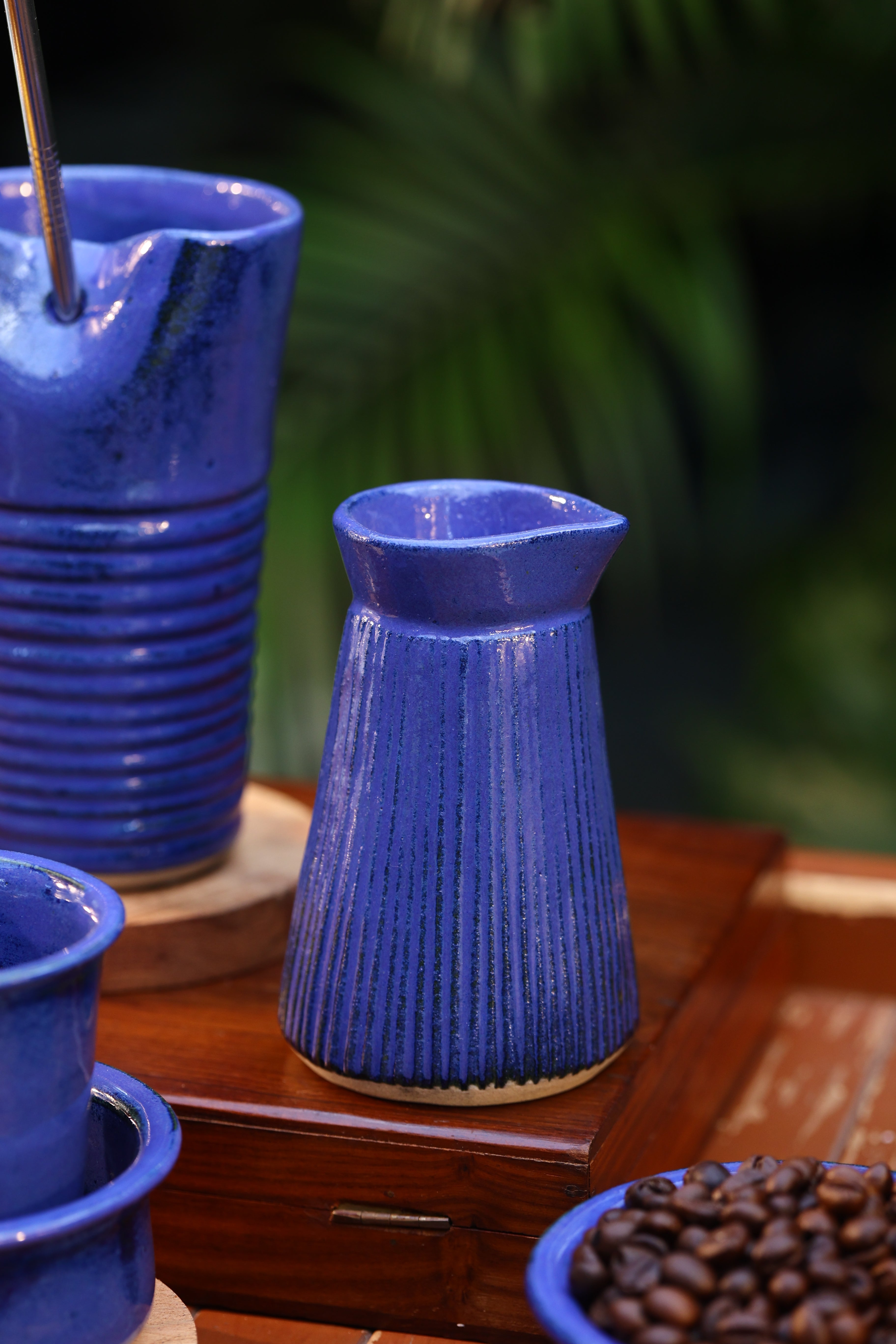 Close-up of blue plastic bottles with textured ends, ceramic tableware India, pottery brands in India