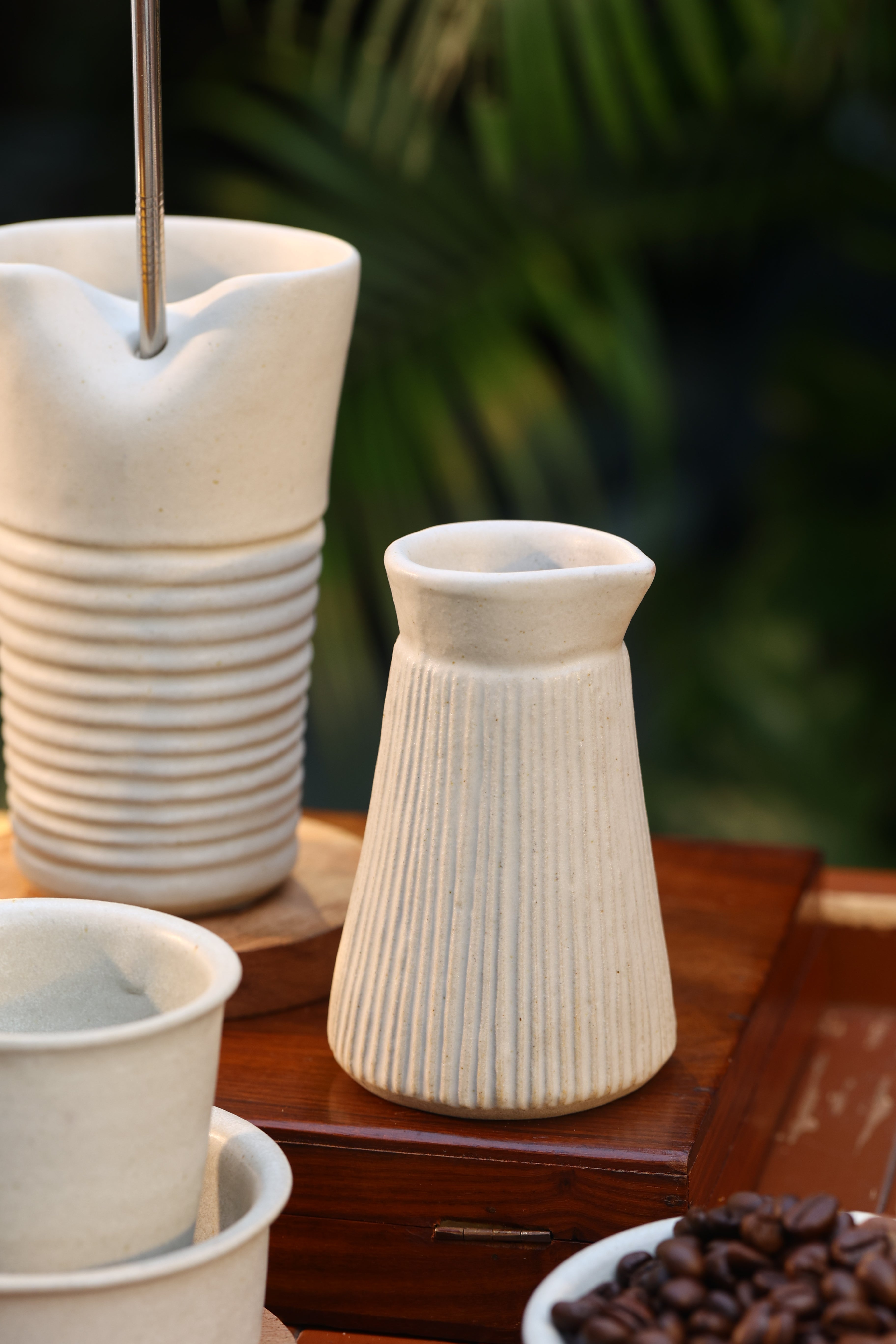 Set of white ceramic vases on a wooden surface, ceramic tableware India, pottery brands in India