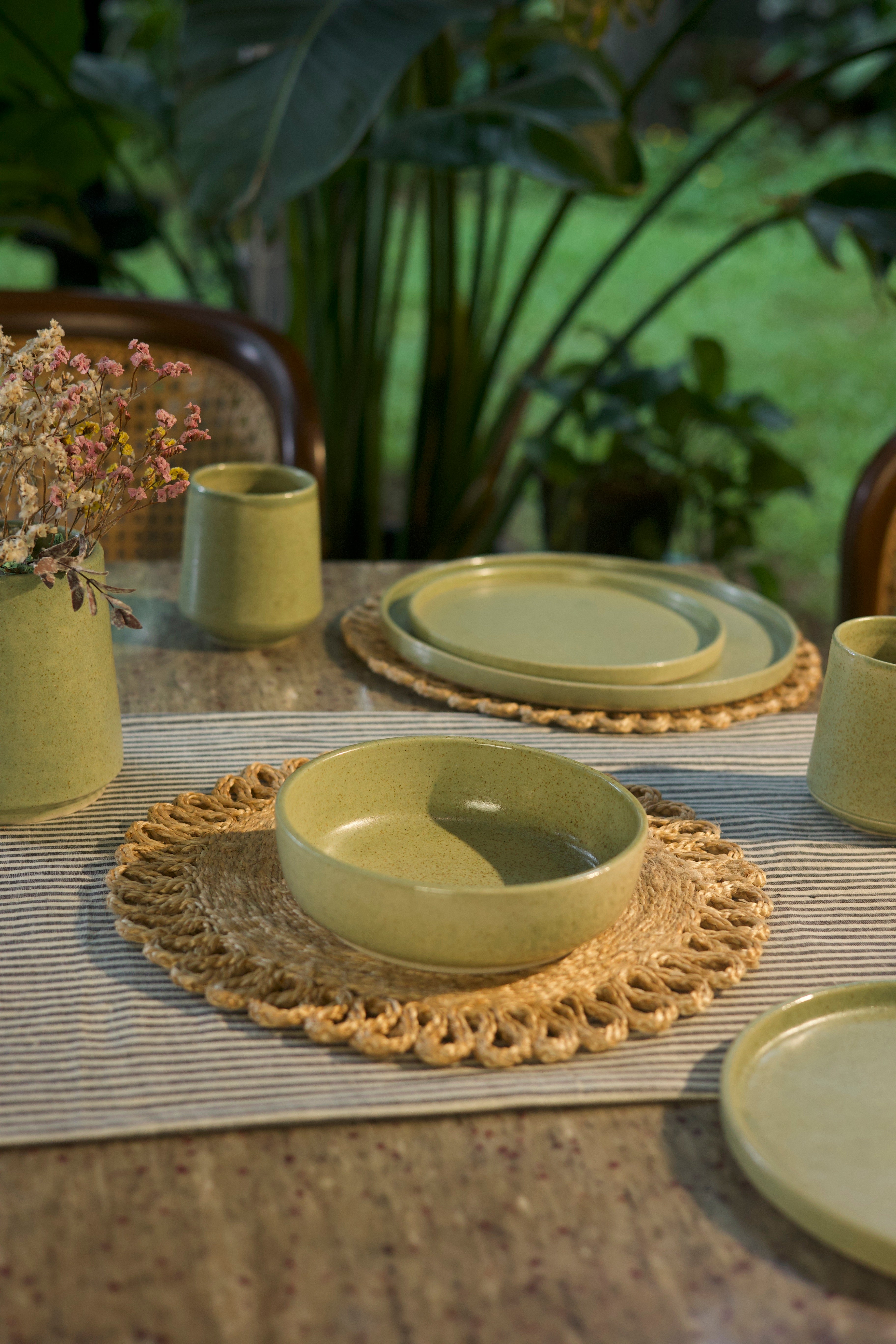 Green ceramic dishes on a table artisanal serveware India, handcrafted plates and bowls
