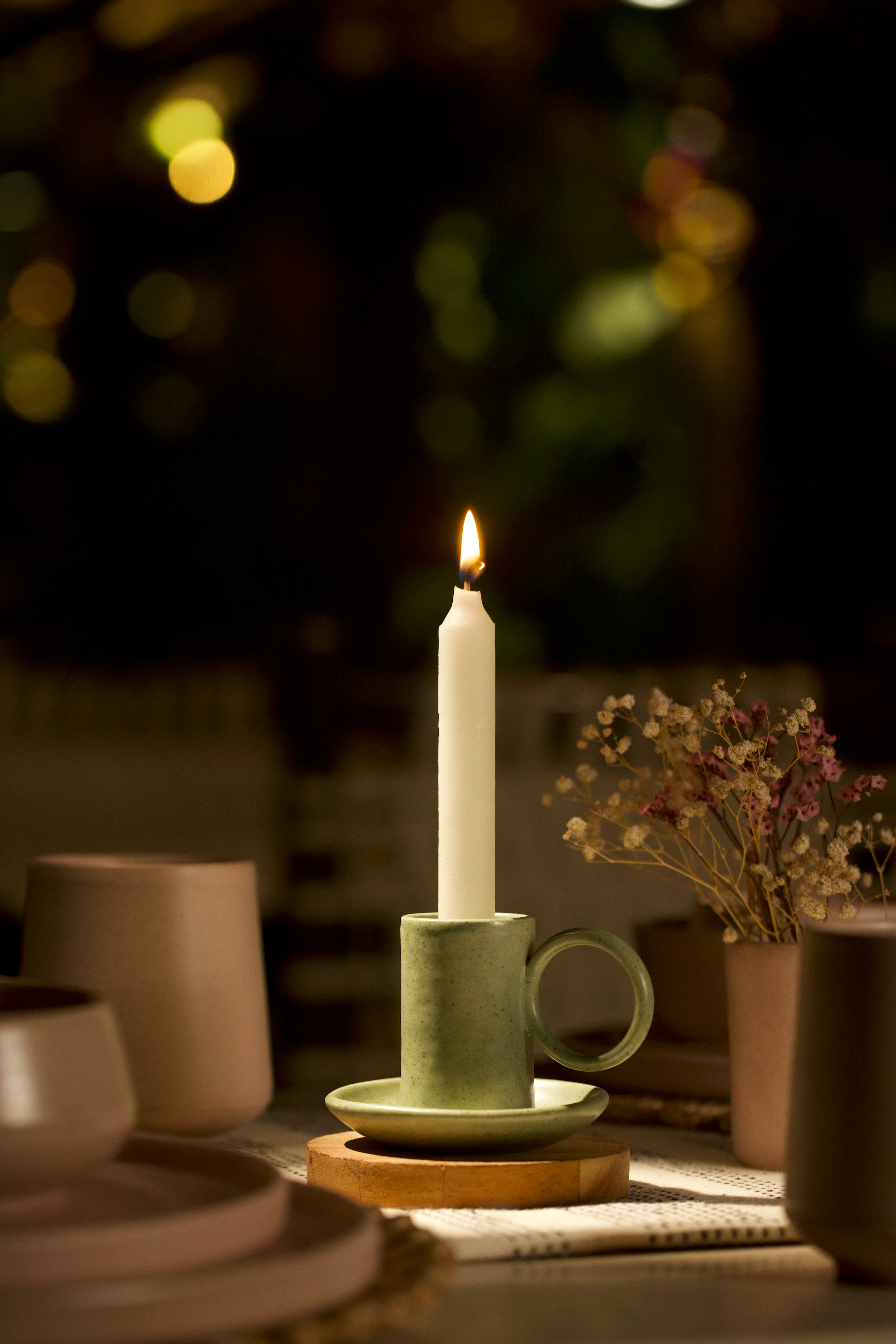 A green holder on a table, handmade ceramics India, ceramic home décor online