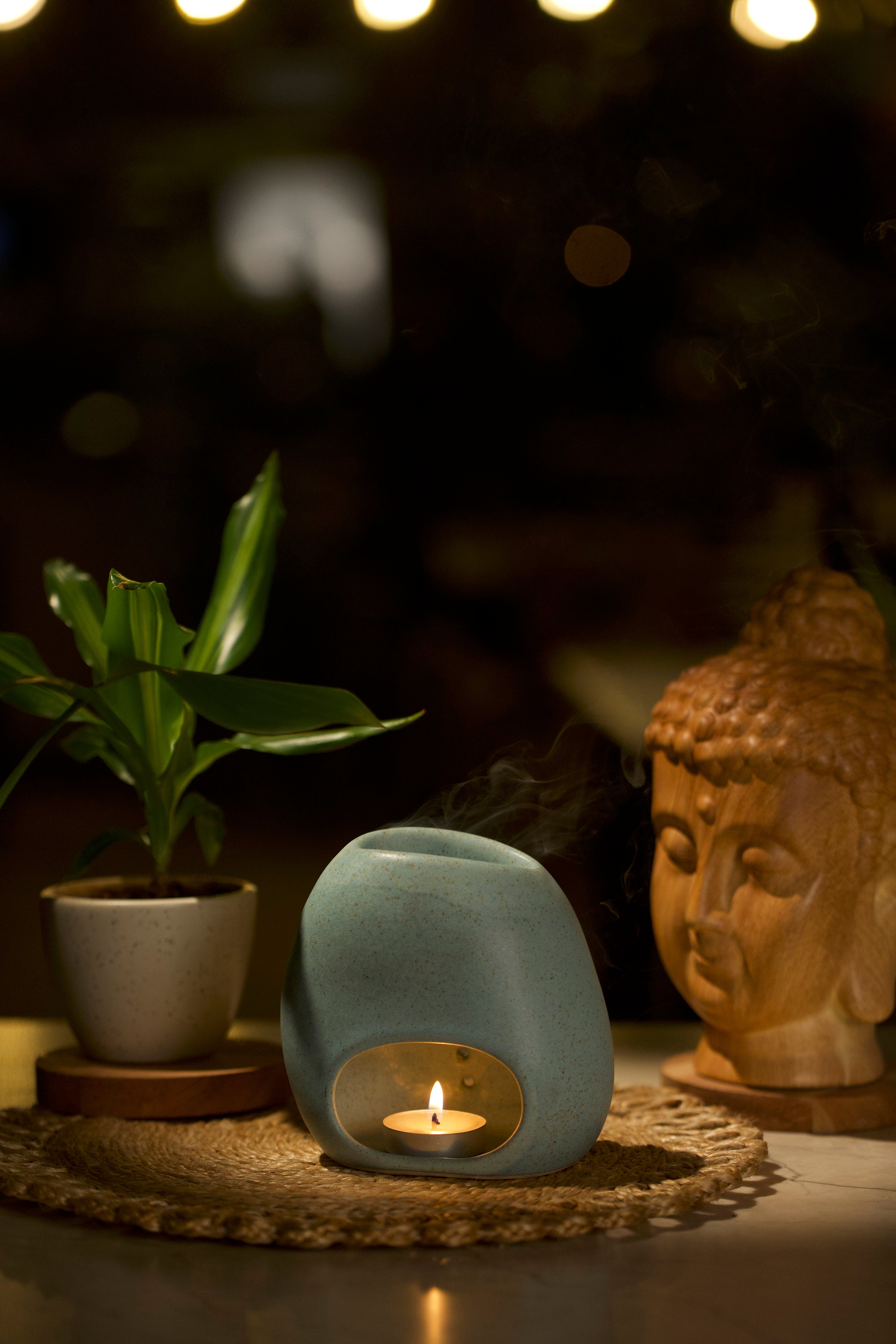 Mint Green Ceramic diffuser with a lit candle inside, Home decor shop online, artisanal home décor India