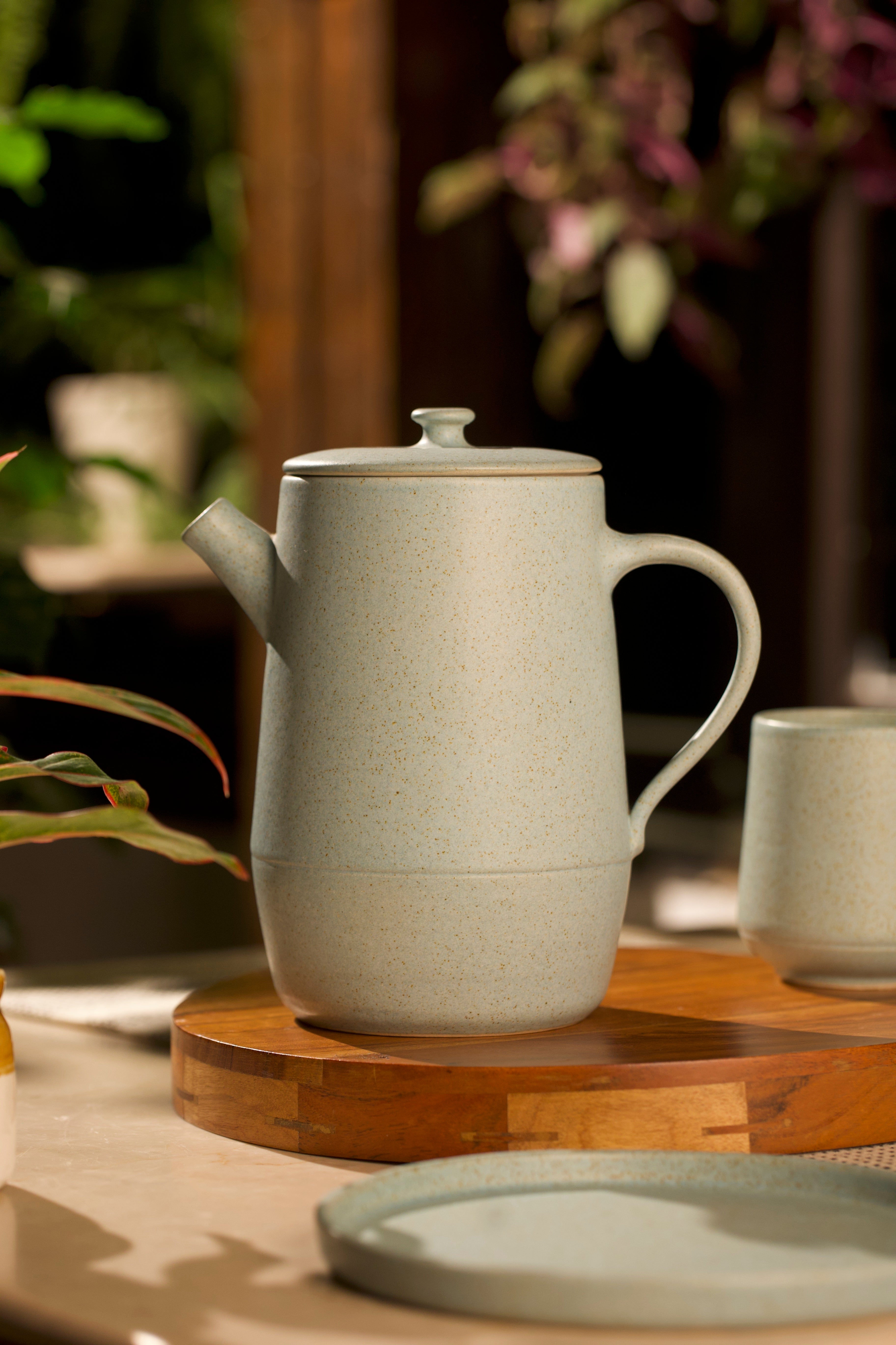 Gray ceramic teapot and mug on a wooden surface, ceramic tableware India, pottery brands in India