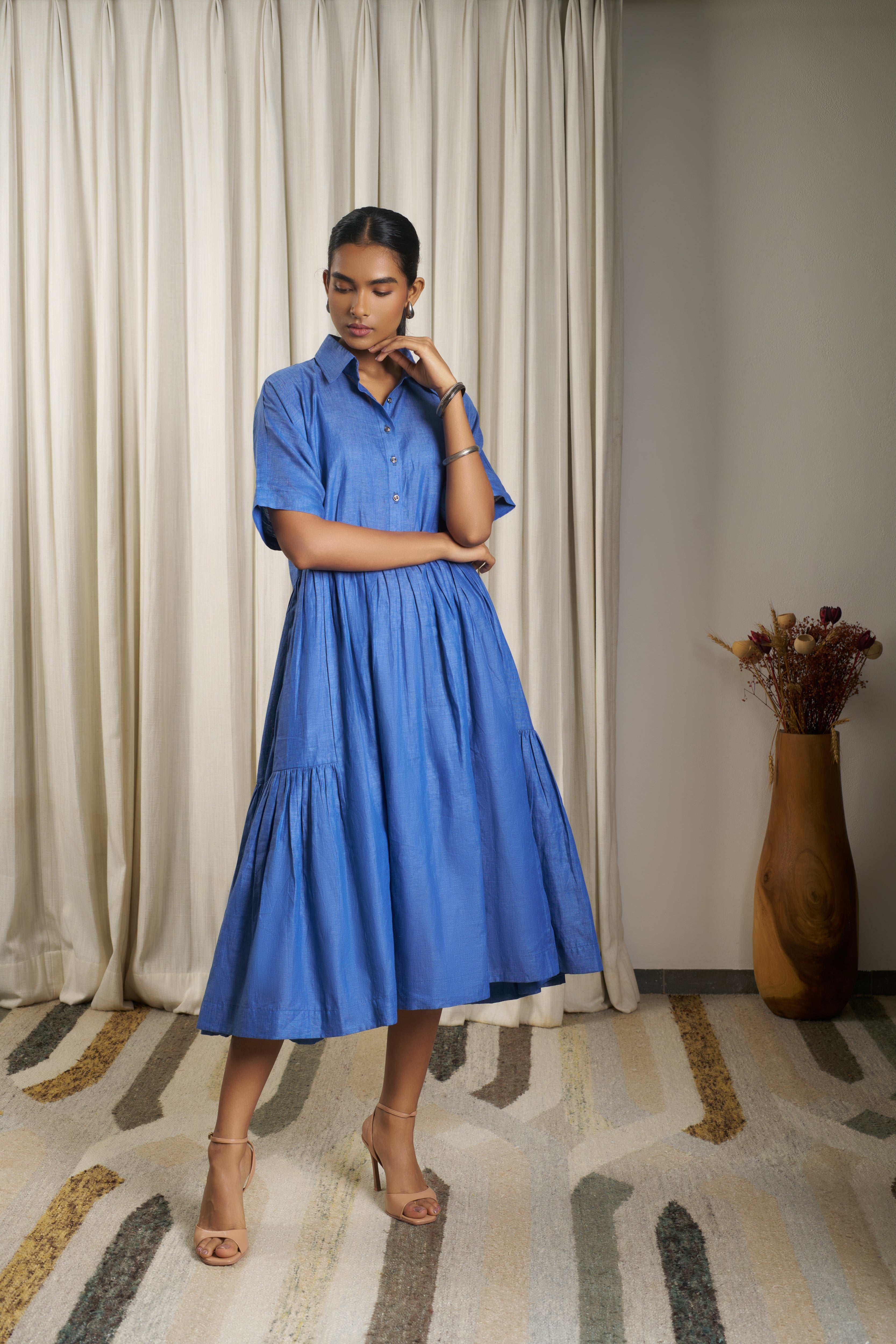 Woman wearing a blue dress. linen dresses for women India, minimalist clothing brands India