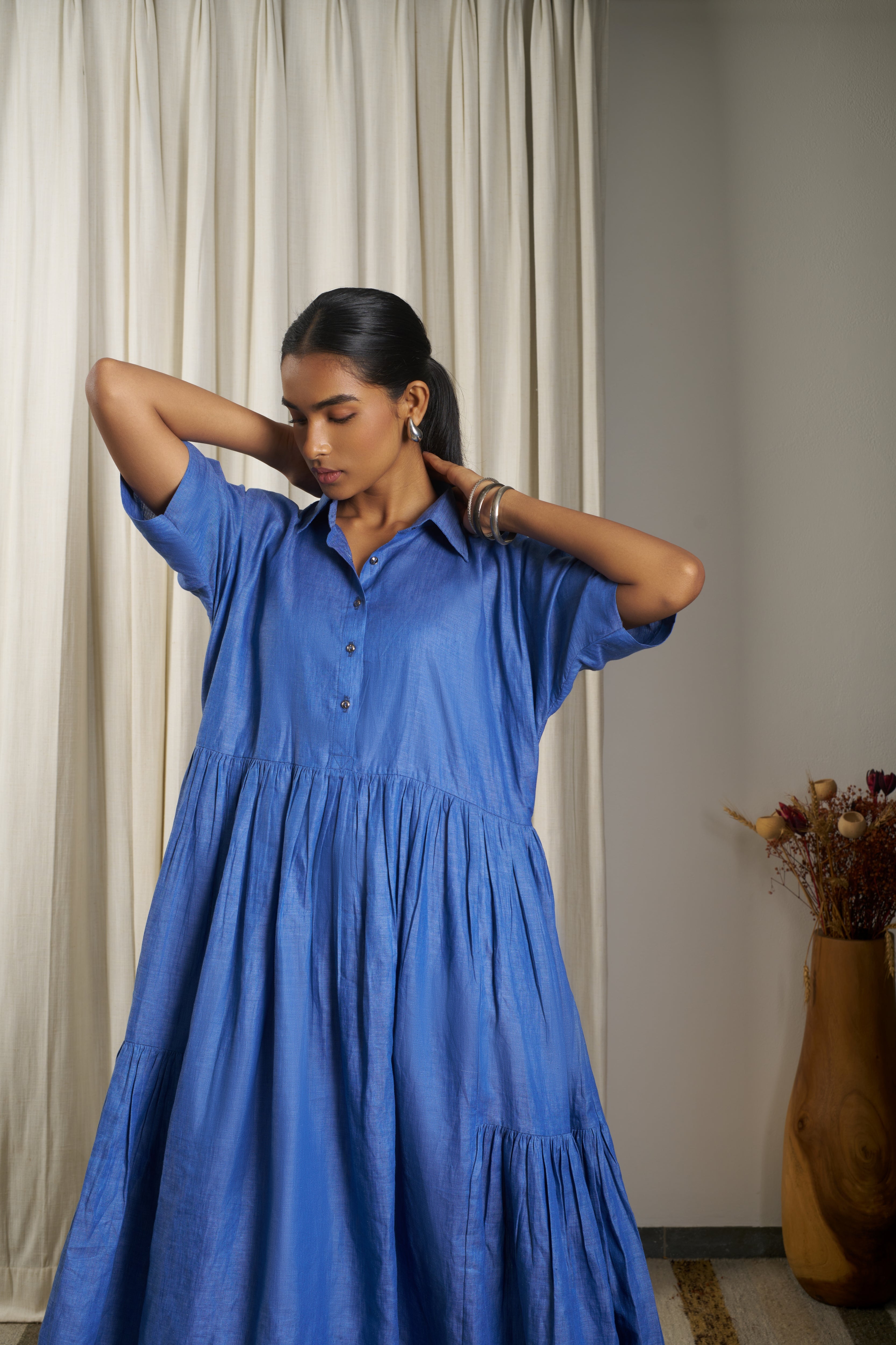 Woman wearing a blue dress. linen dresses for women India, minimalist clothing brands India