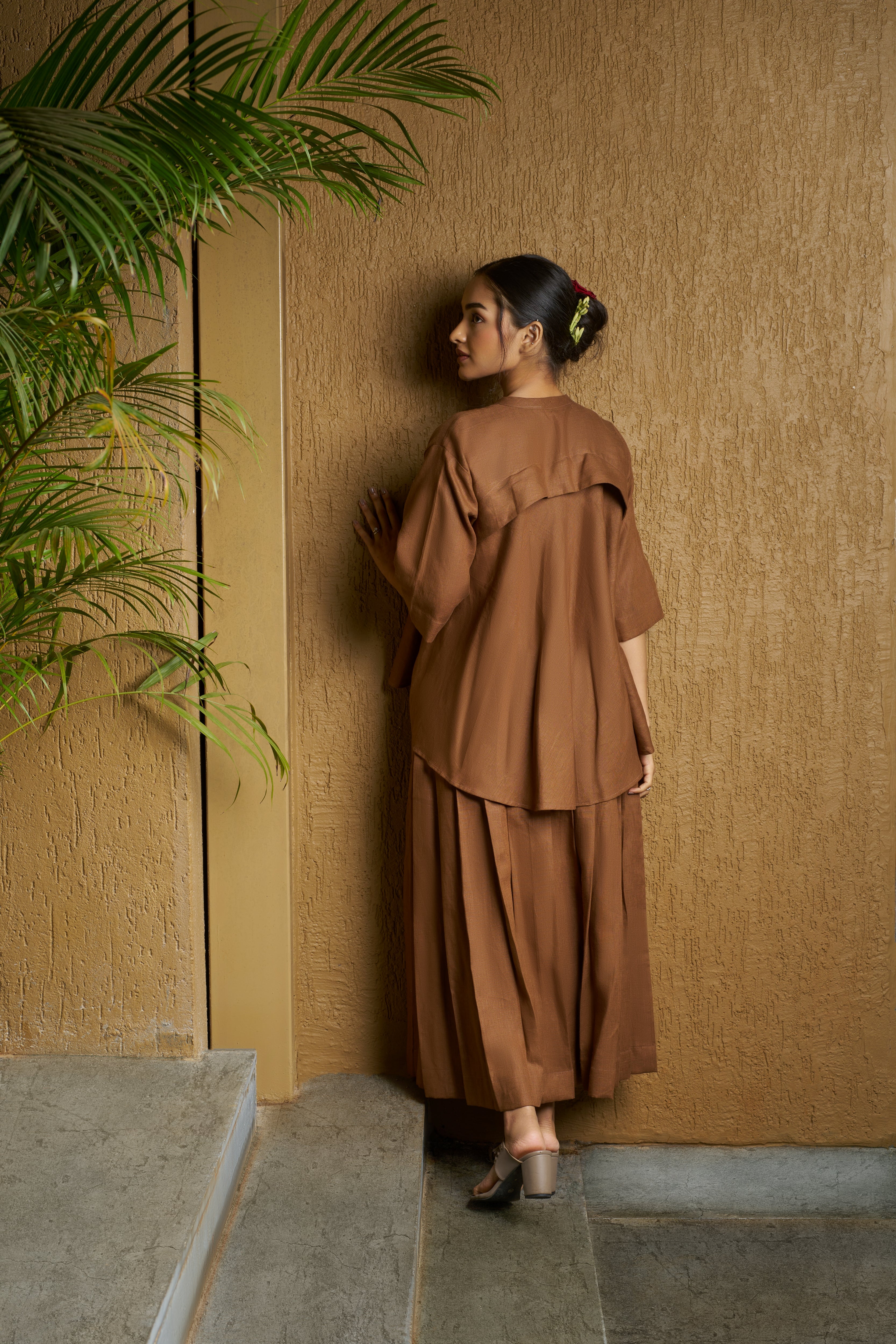 Woman wearing a brown outfit with a floral design. timeless women’s fashion, 100% linen clothes India