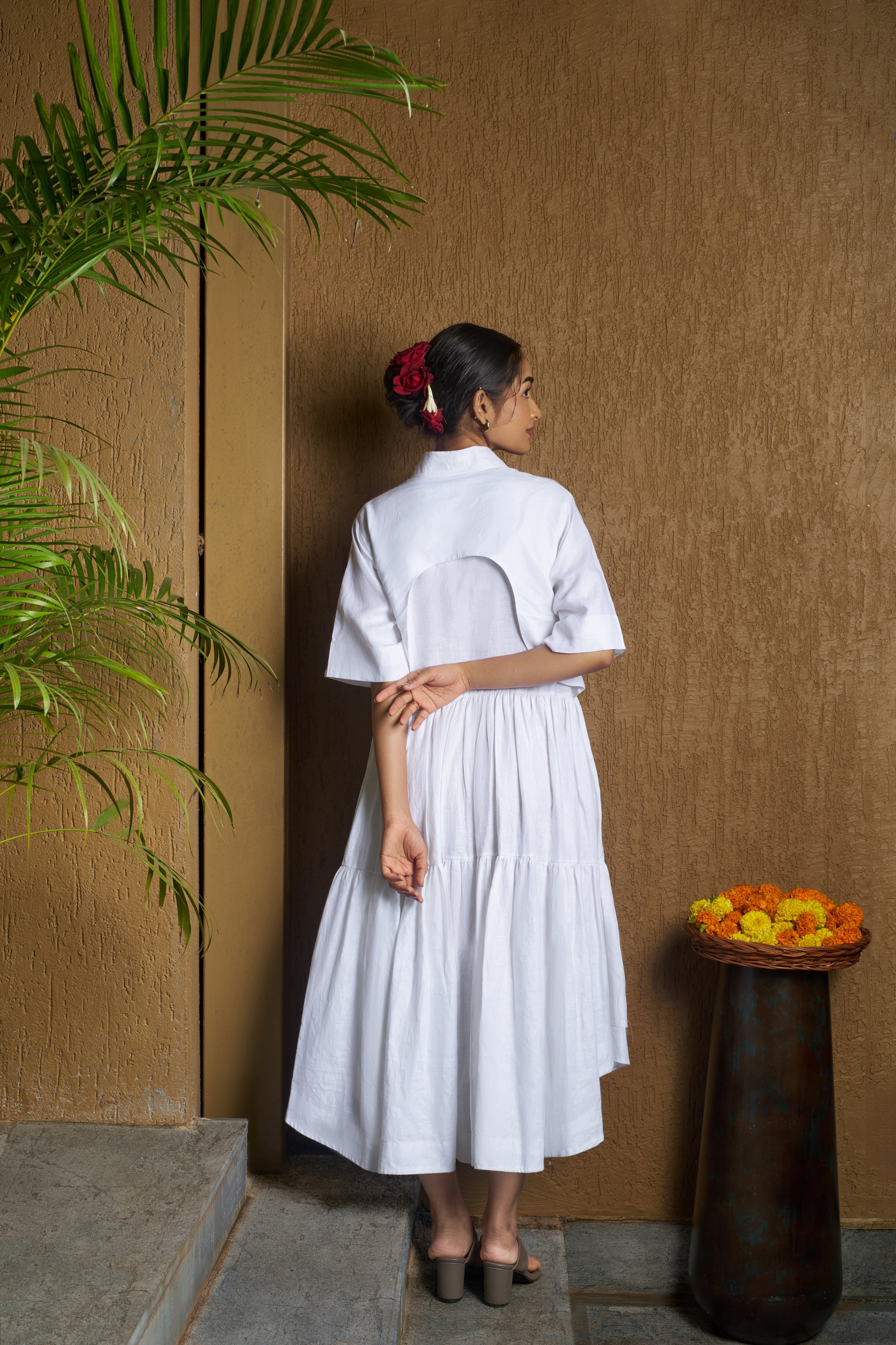 Woman wearing a white dress with a moon embroidery. comfortable linen dresses India, Casual linen fashion