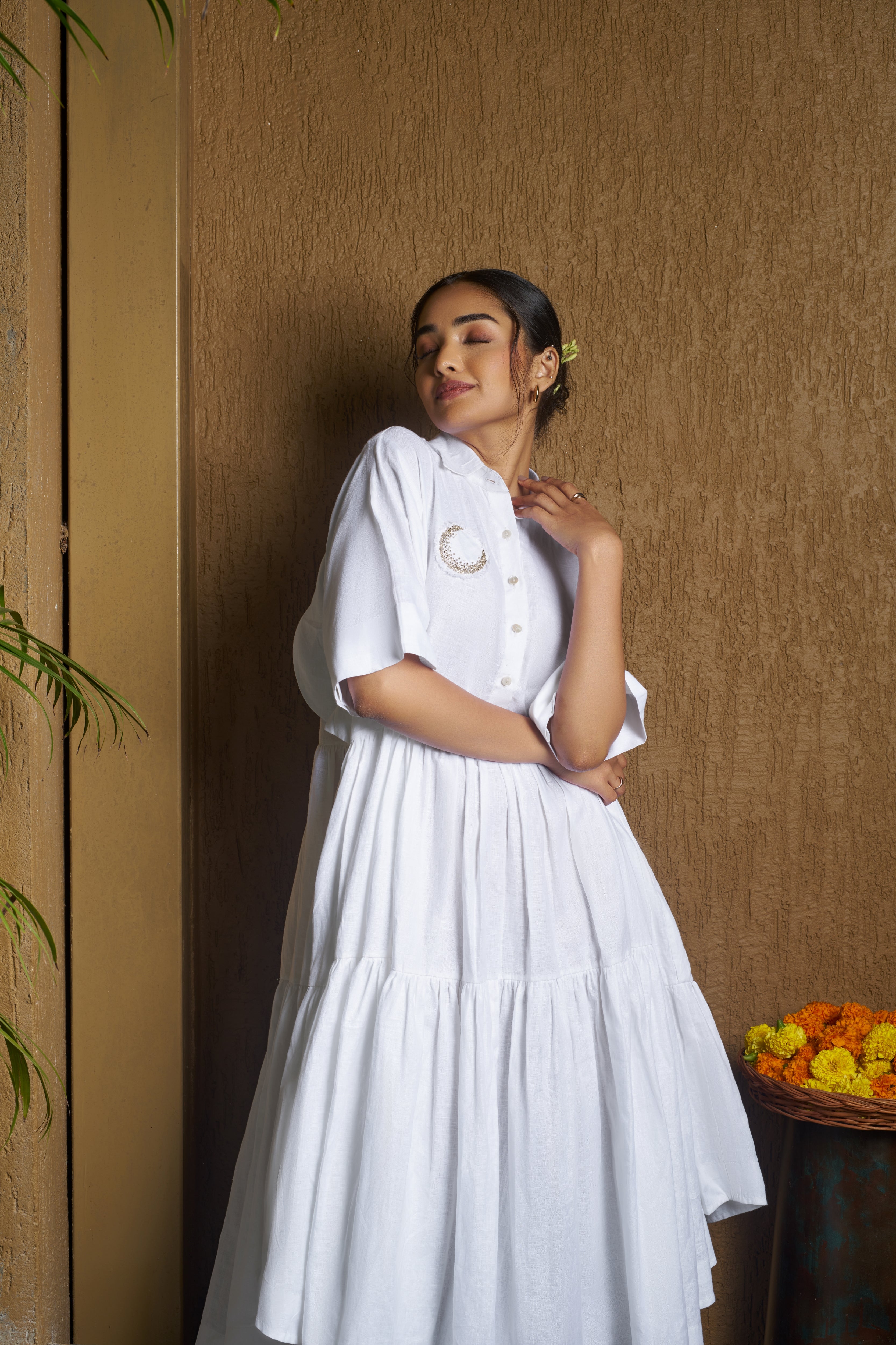 Woman wearing a white dress with a moon embroidery.comfortable linen dresses India, Casual linen fashion