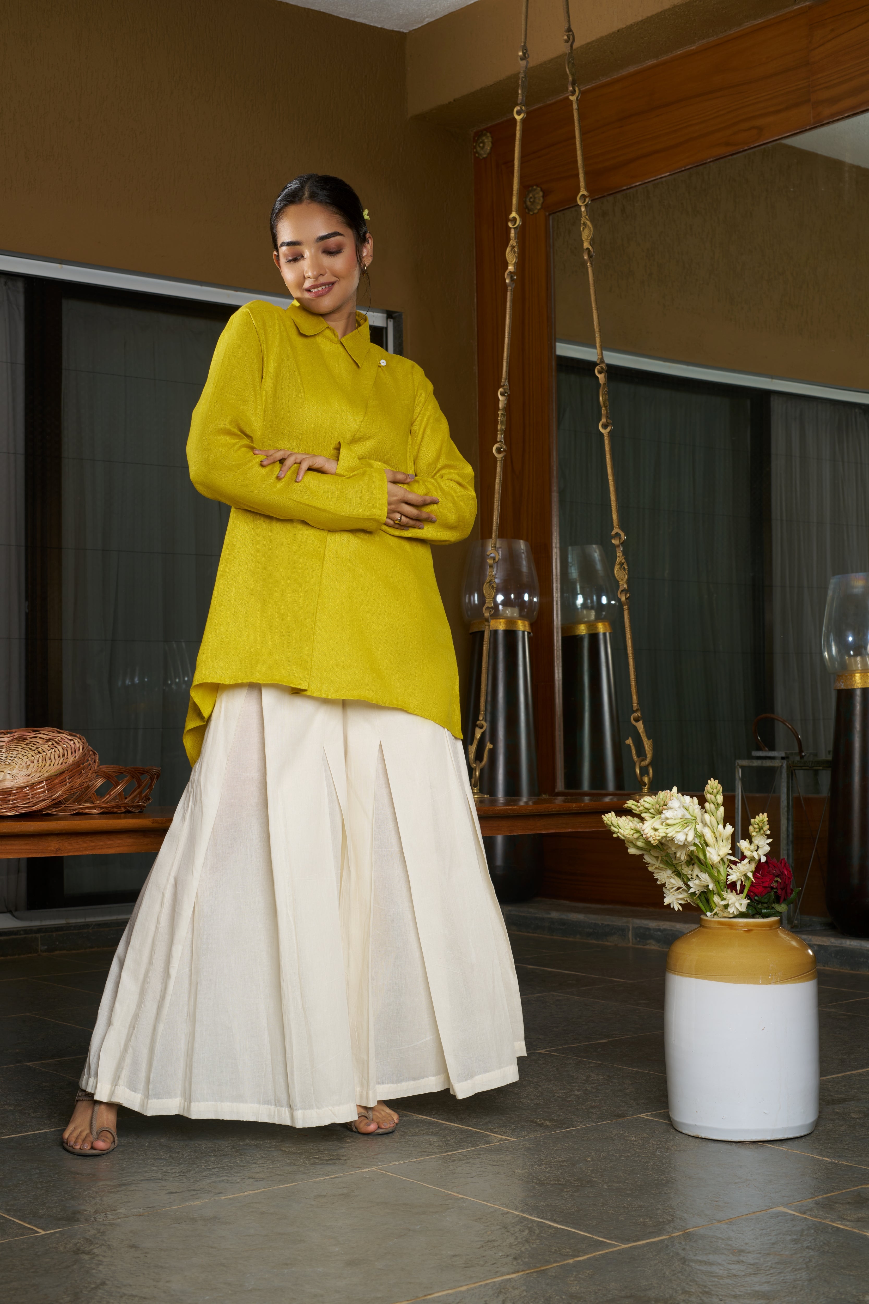Woman in a yellow top and white skirt standing in a room. everyday sustainable fashion India,
linen co-ord sets India