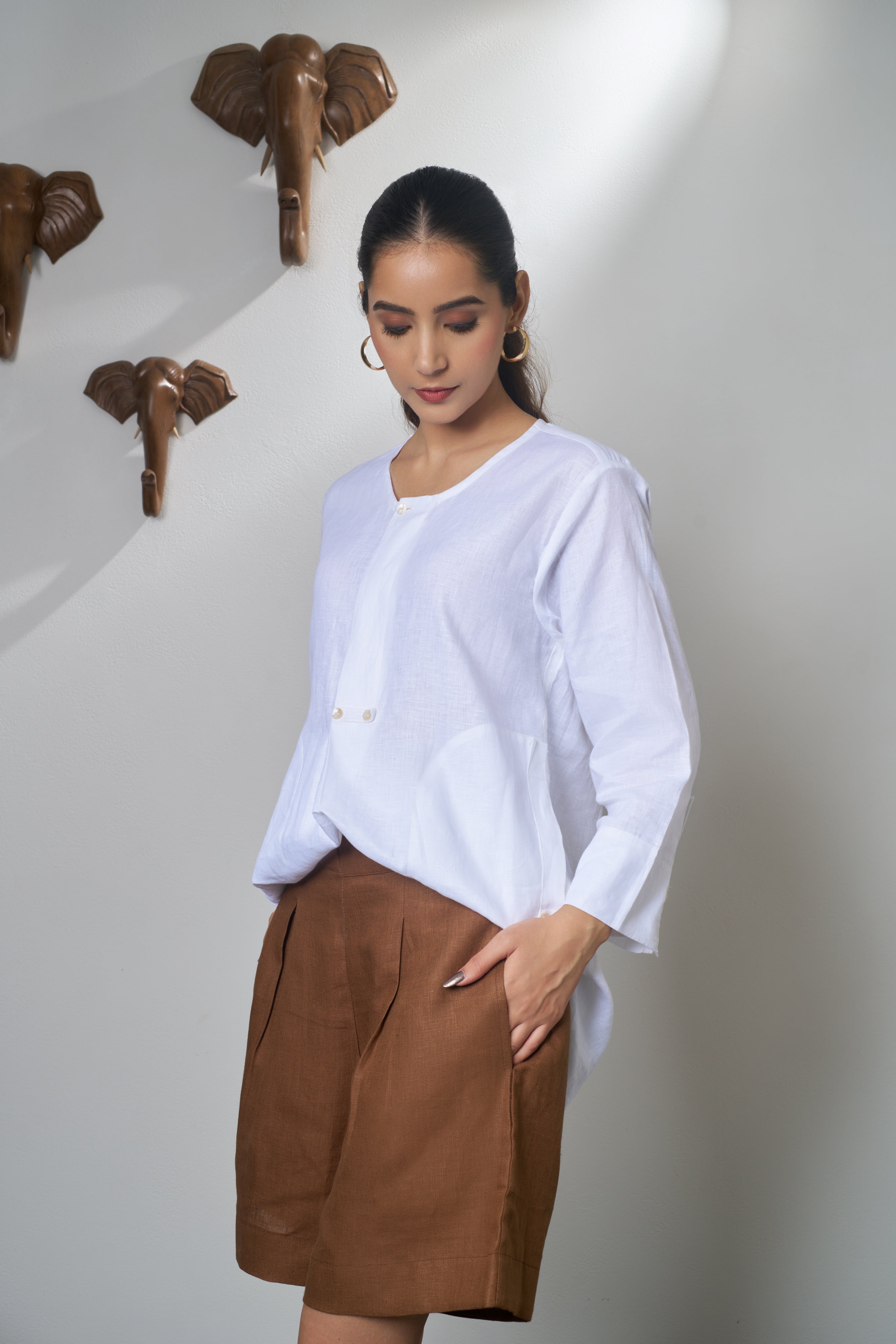 Woman wearing a white shirt and brown shorts. Linen clothing mumbai,
Casual linen fashion