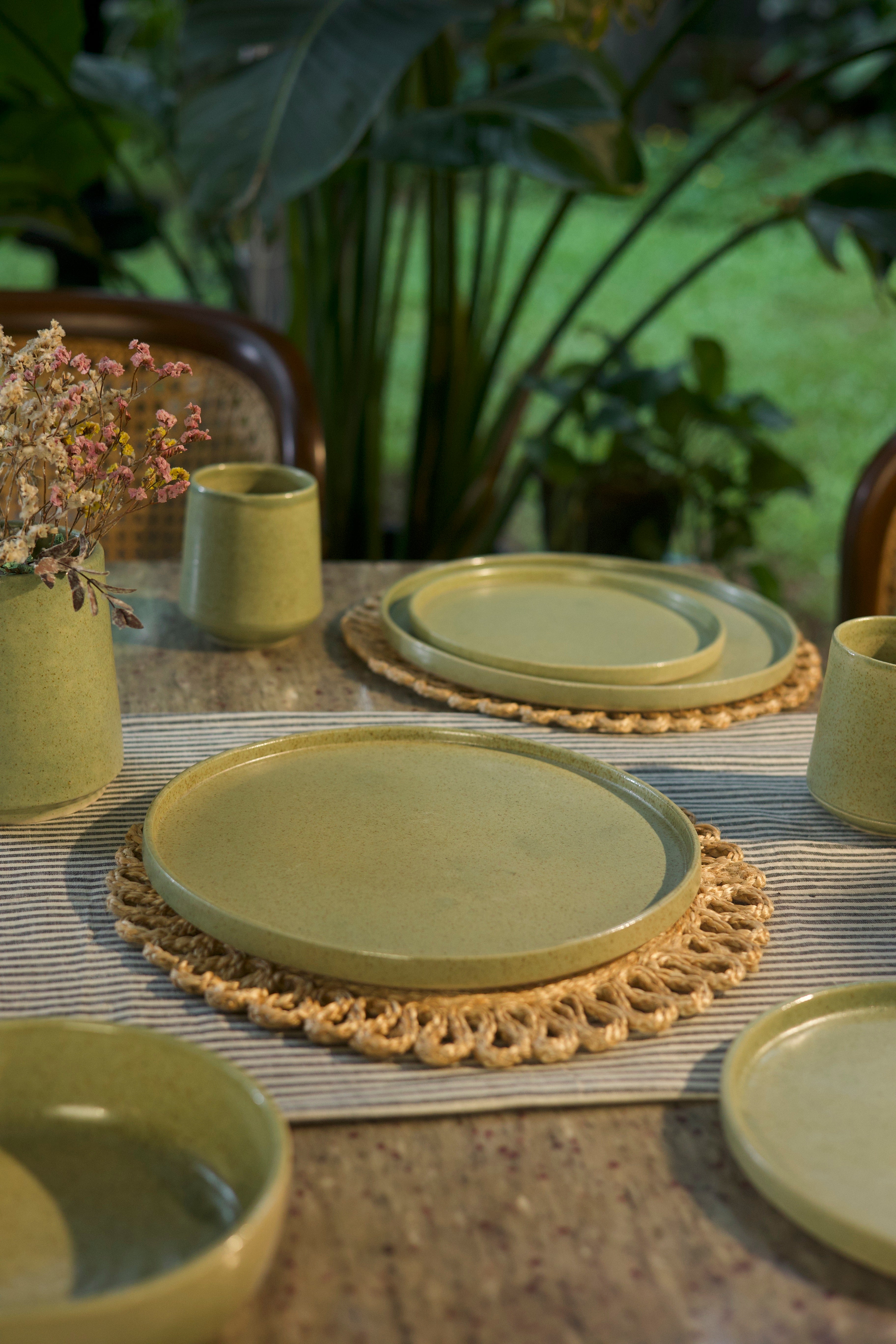 Green ceramic plates and cups on a table, handmade dinnerware India, handcrafted plates and bowls