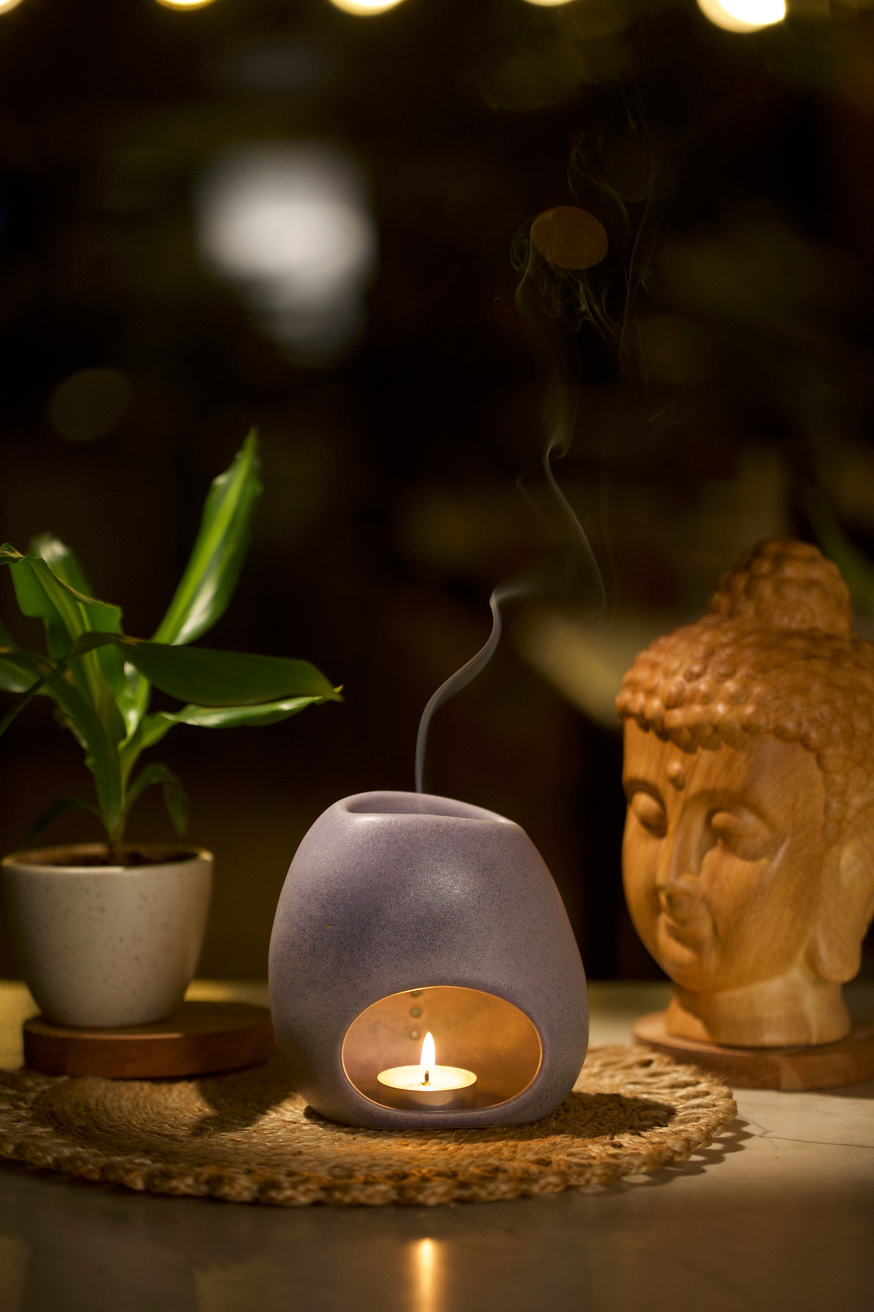 Ceramic diffuser with a lit candle inside, Home decor shop online, artisanal home décor India