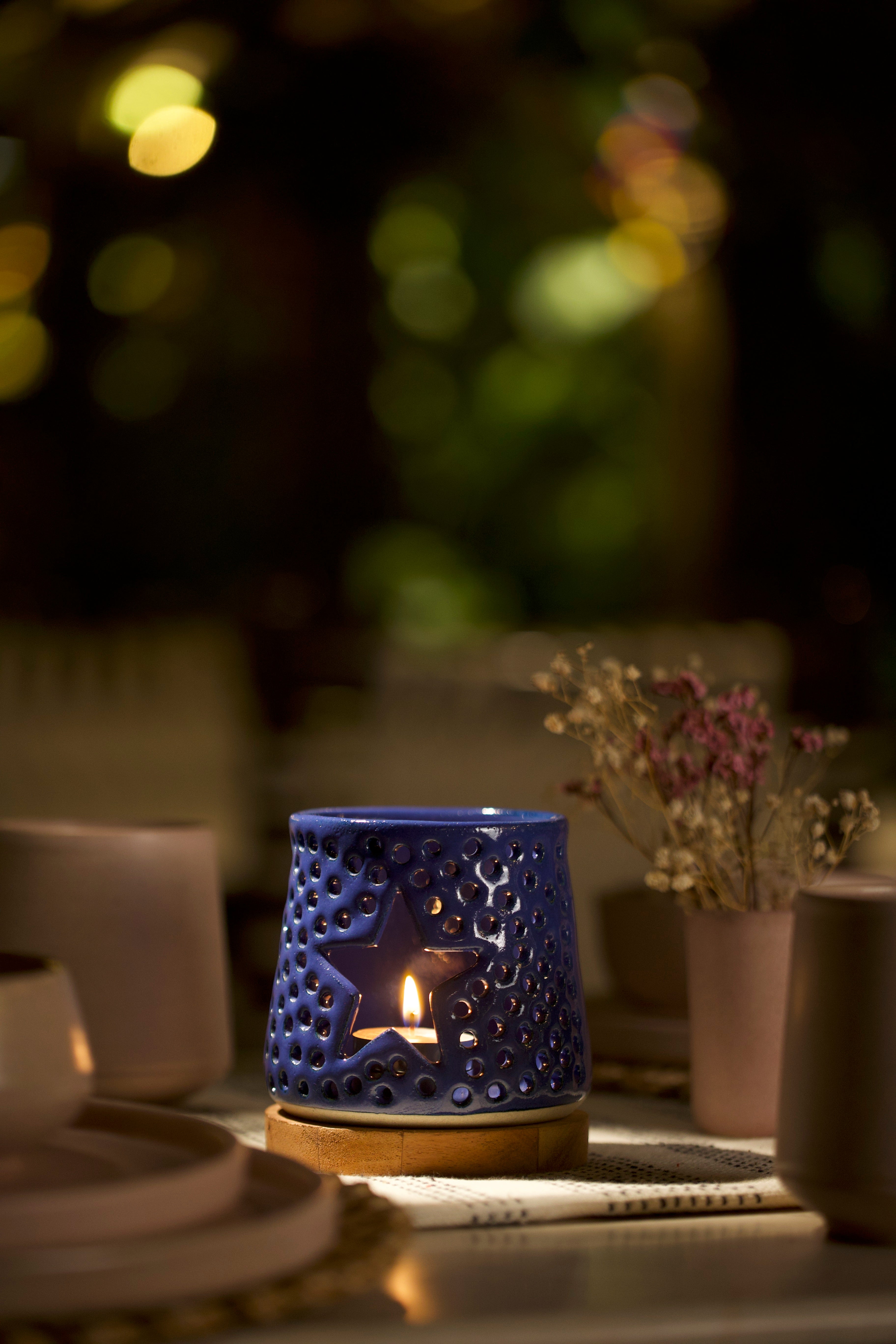 A blue decorative ceramic lantern with intricate design. ceramic home décor online, minimalist home décor India