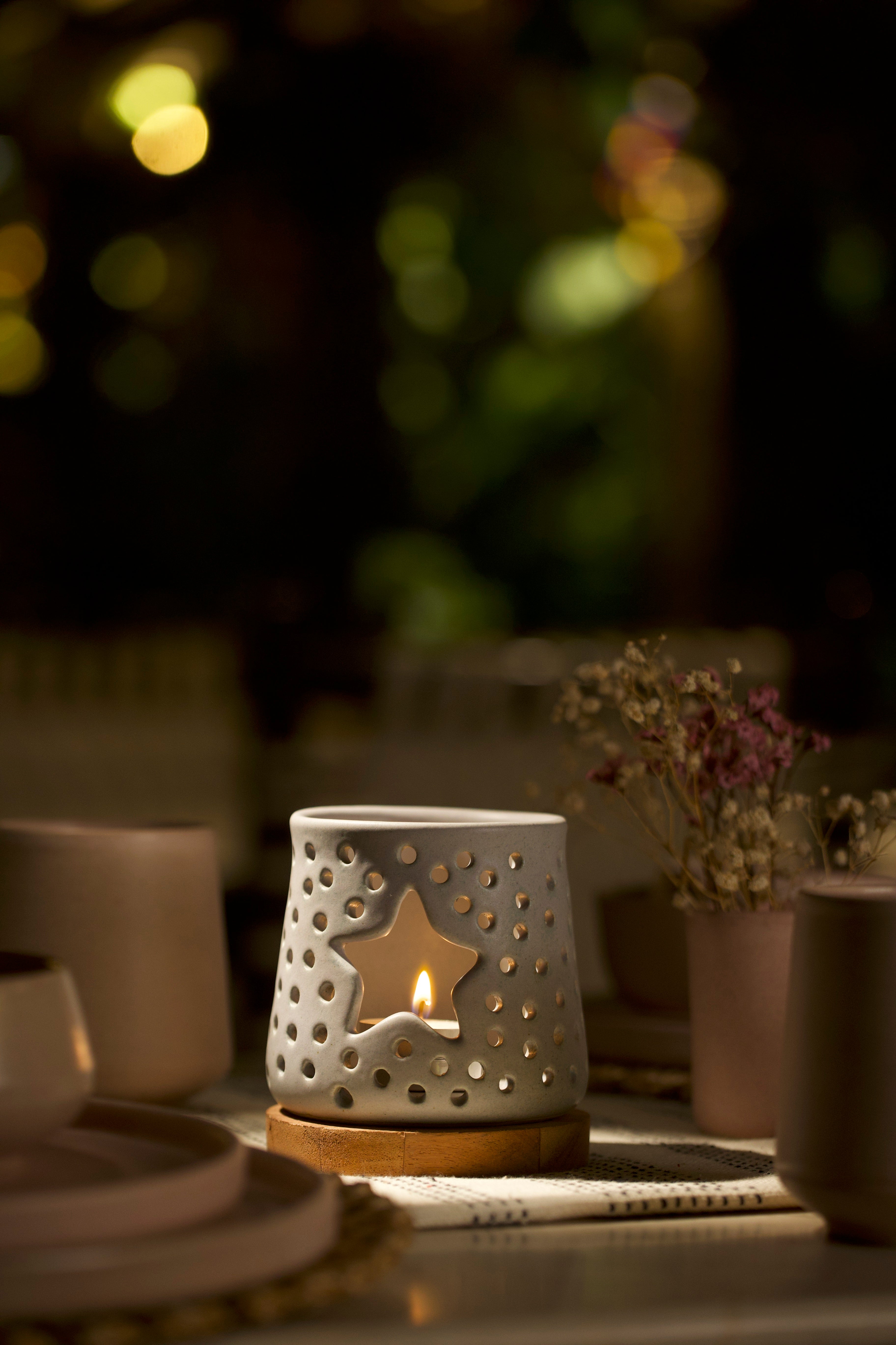 A white decorative ceramic lantern with intricate design. ceramic home décor online, minimalist home décor India