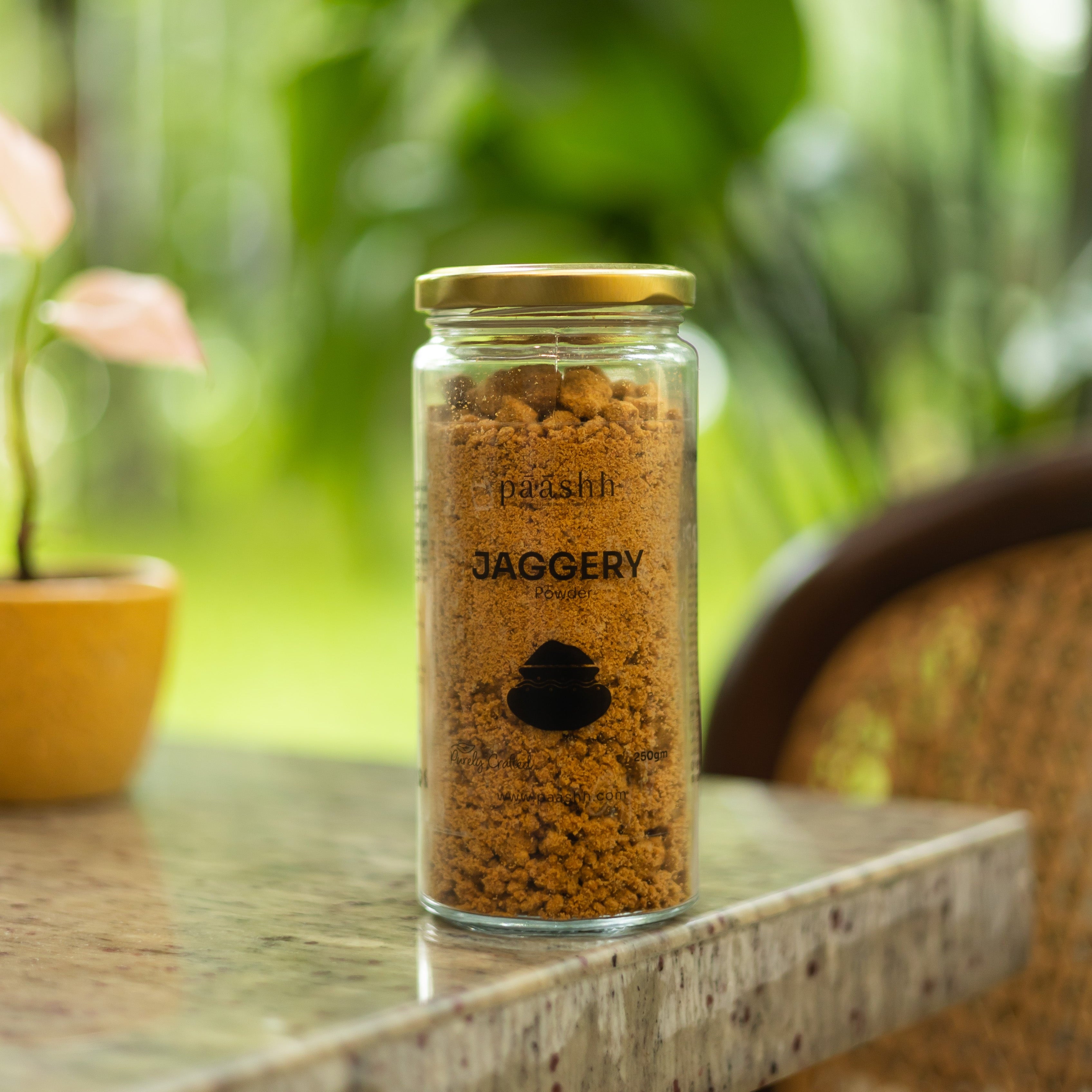 Jar of paashh jaggery powder on a table,  organic jaggery powder India, natural sweeteners India