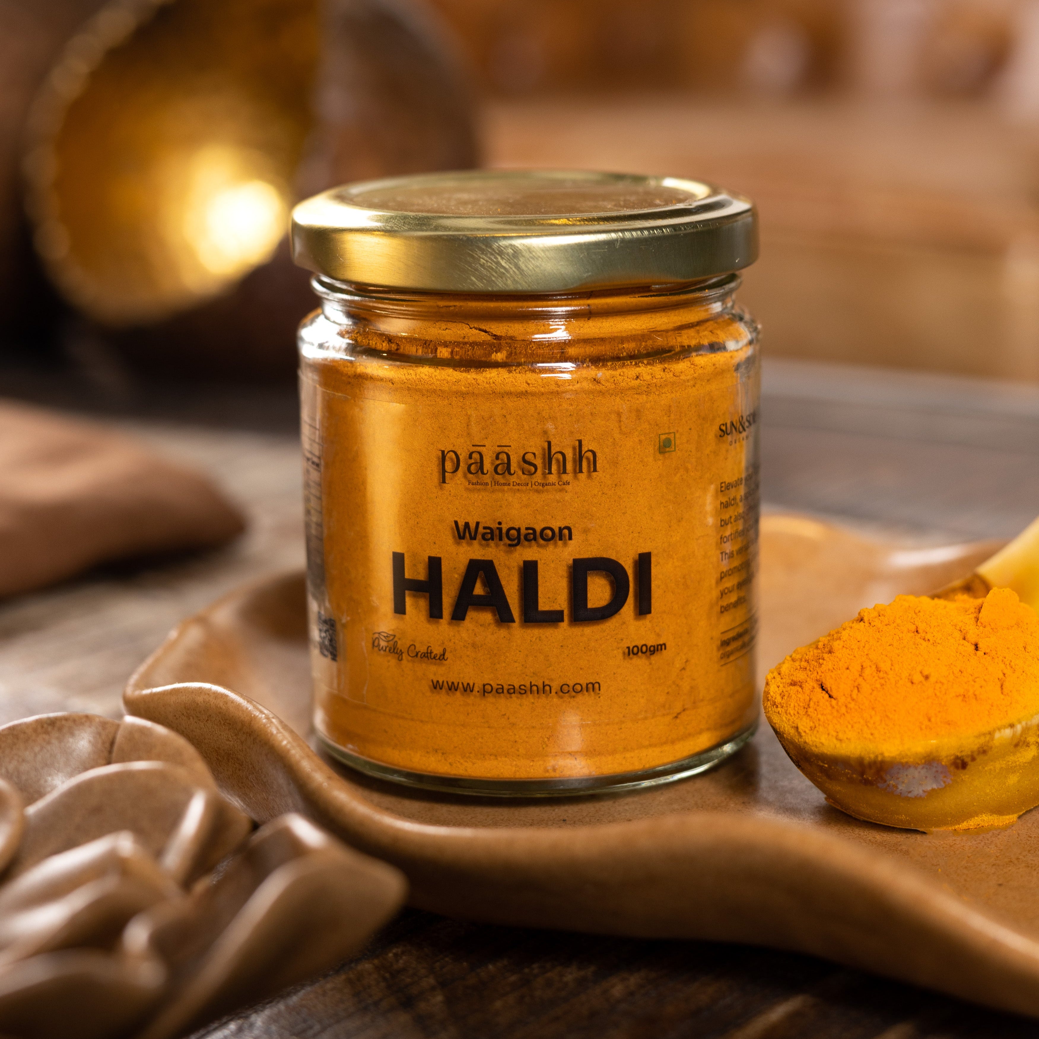 Jar of Waigon Haldi (Turmeric) on a wooden surface. organic spices India, organic kitchen ingredients