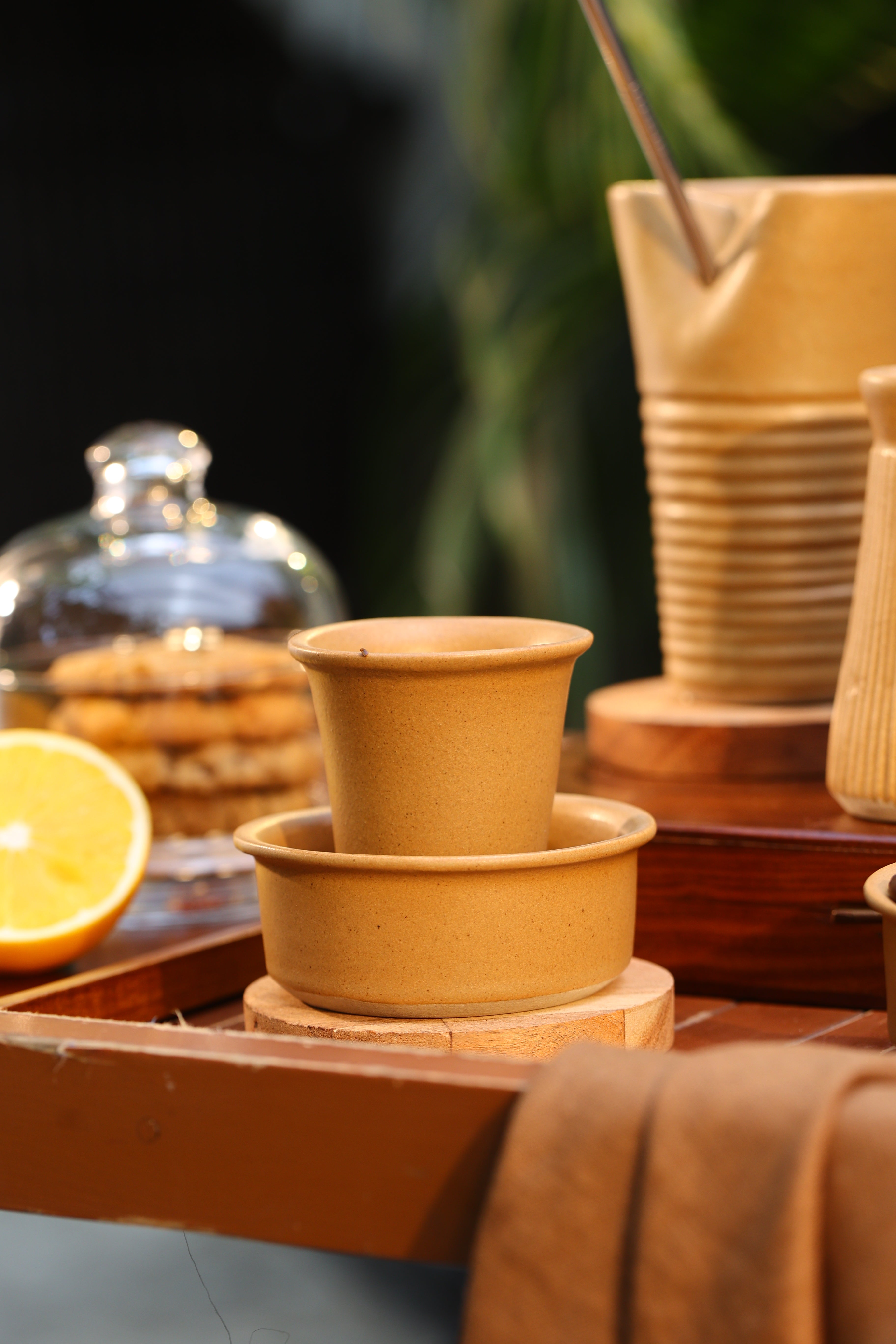 Close-up of a mustard ceramic coffee pot and cup on a wooden surface, ceramic coffee mugs online, 
 Indian pottery brands online
