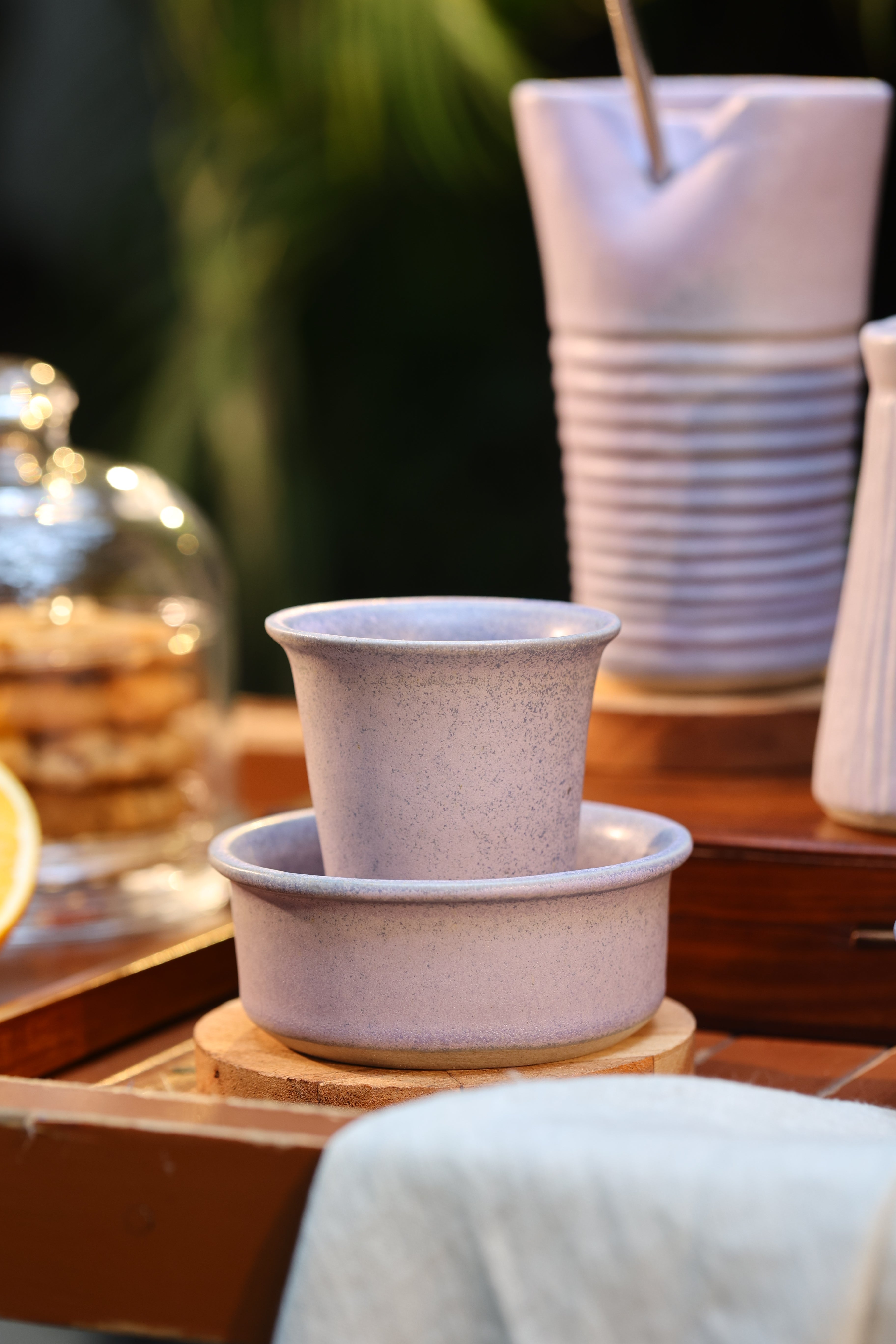 Close-up of a pink ceramic coffee pot and cup on a wooden surface, ceramic coffee mugs online, 
 Indian pottery brands online
