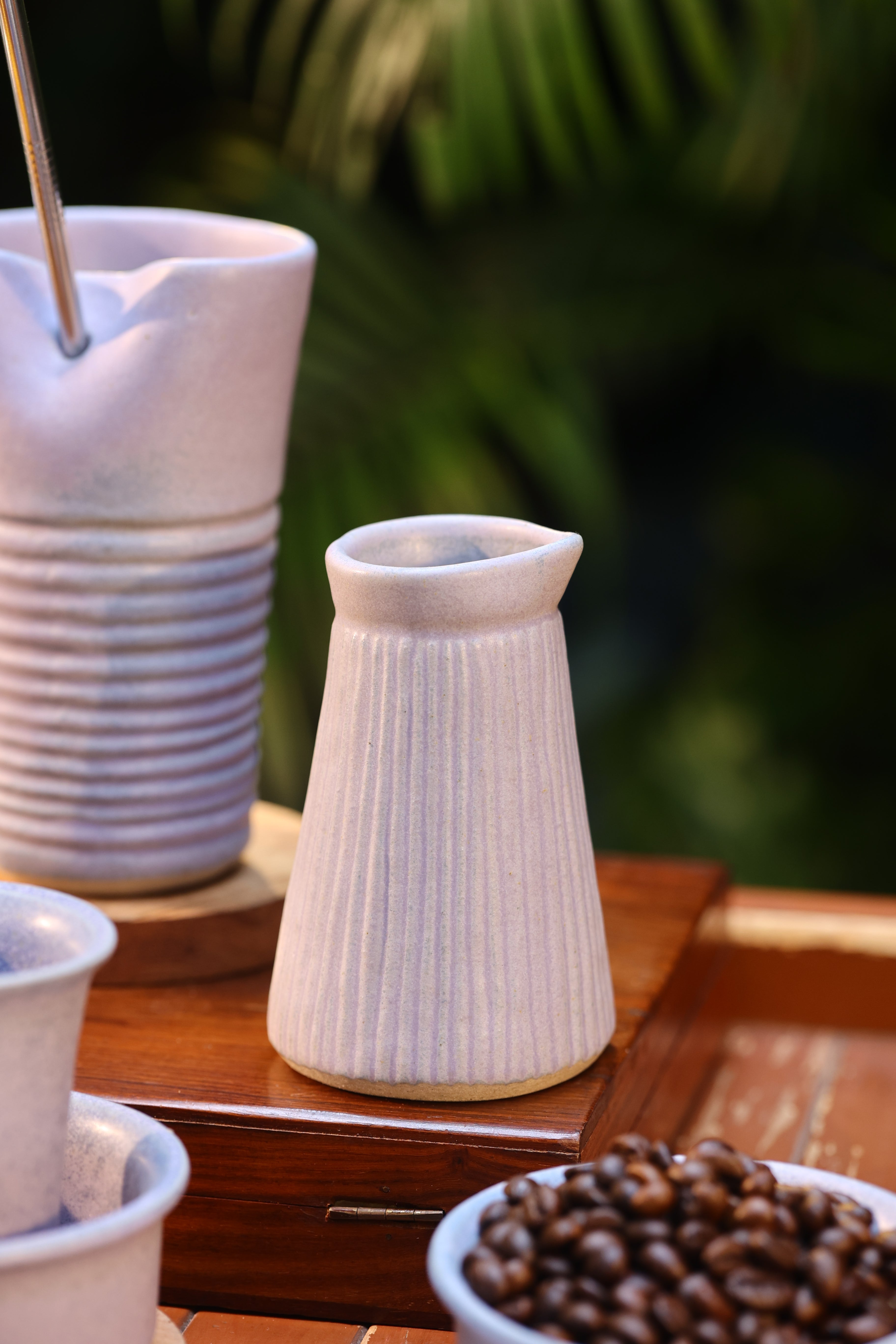 White coffee grinder on a wooden surface, ceramic tableware India, pottery brands in India
