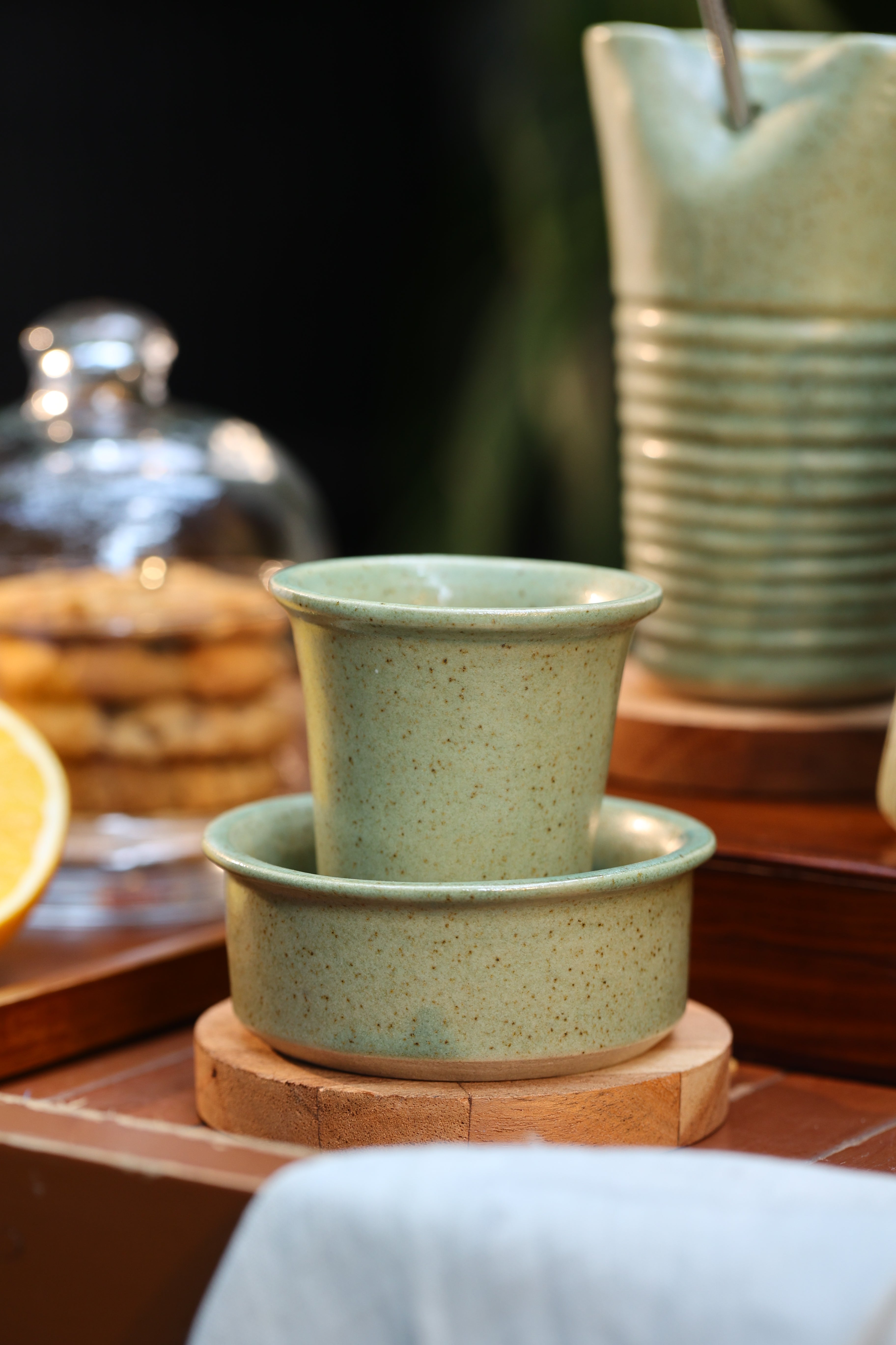 Close-up of a mint ceramic coffee pot and cup on a wooden surface, ceramic coffee mugs online, Indian pottery brands online
