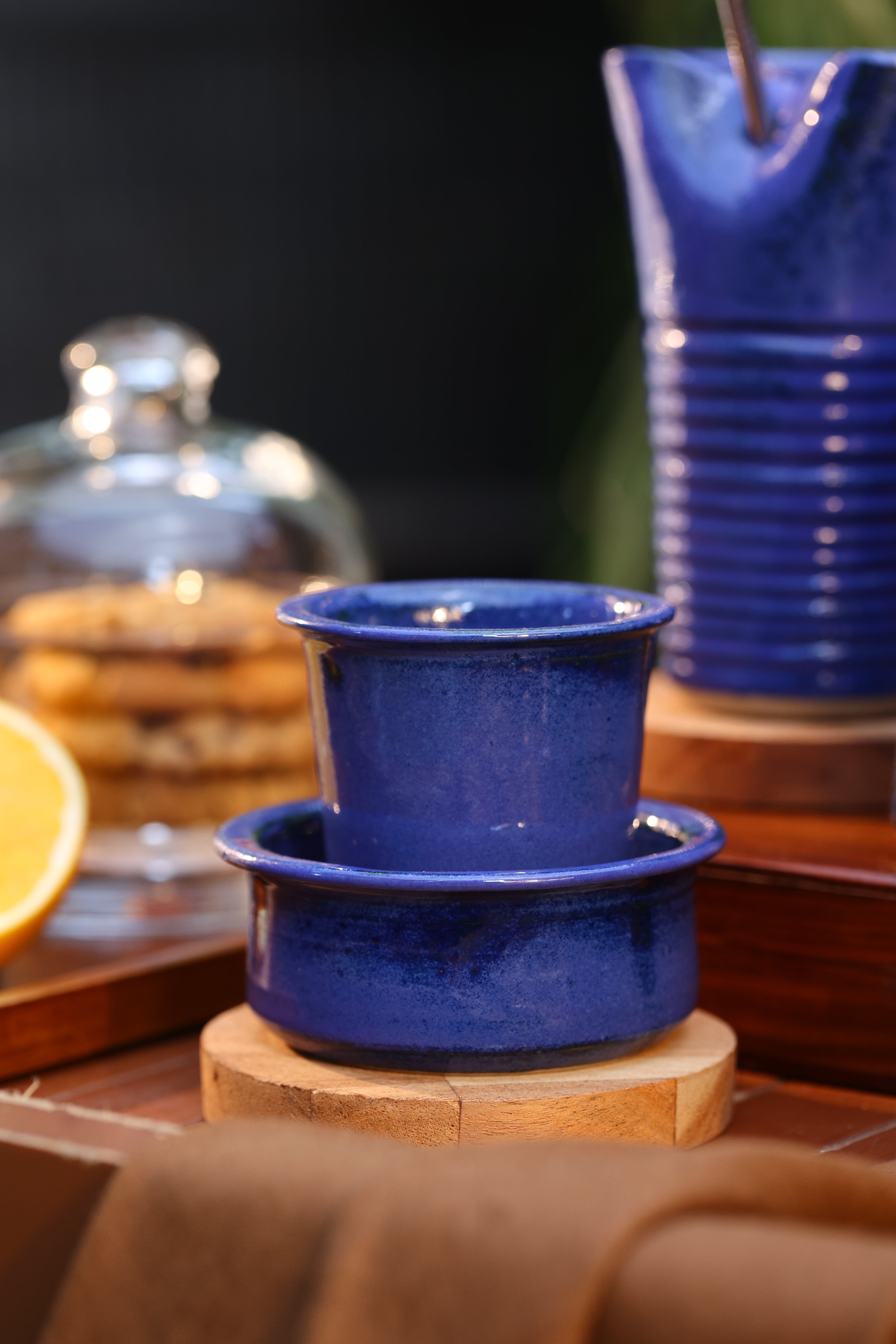 Close-up of a blue ceramic coffee pot and cup on a wooden surface, ceramic coffee mugs online, Indian pottery brands online

