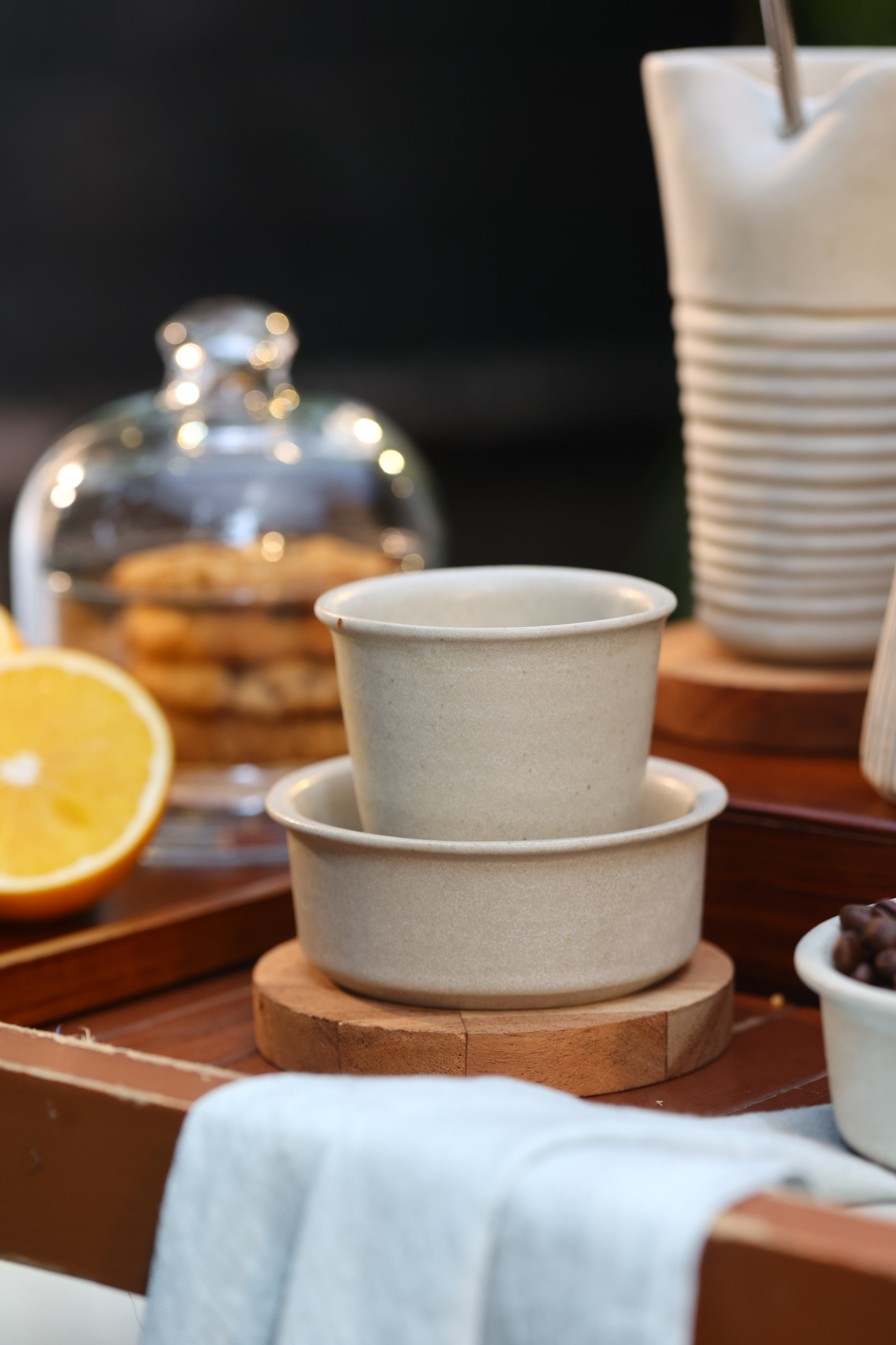 Close-up of a white ceramic coffee pot and cup on a wooden surface, ceramic coffee mugs online, 
 Indian pottery brands online
