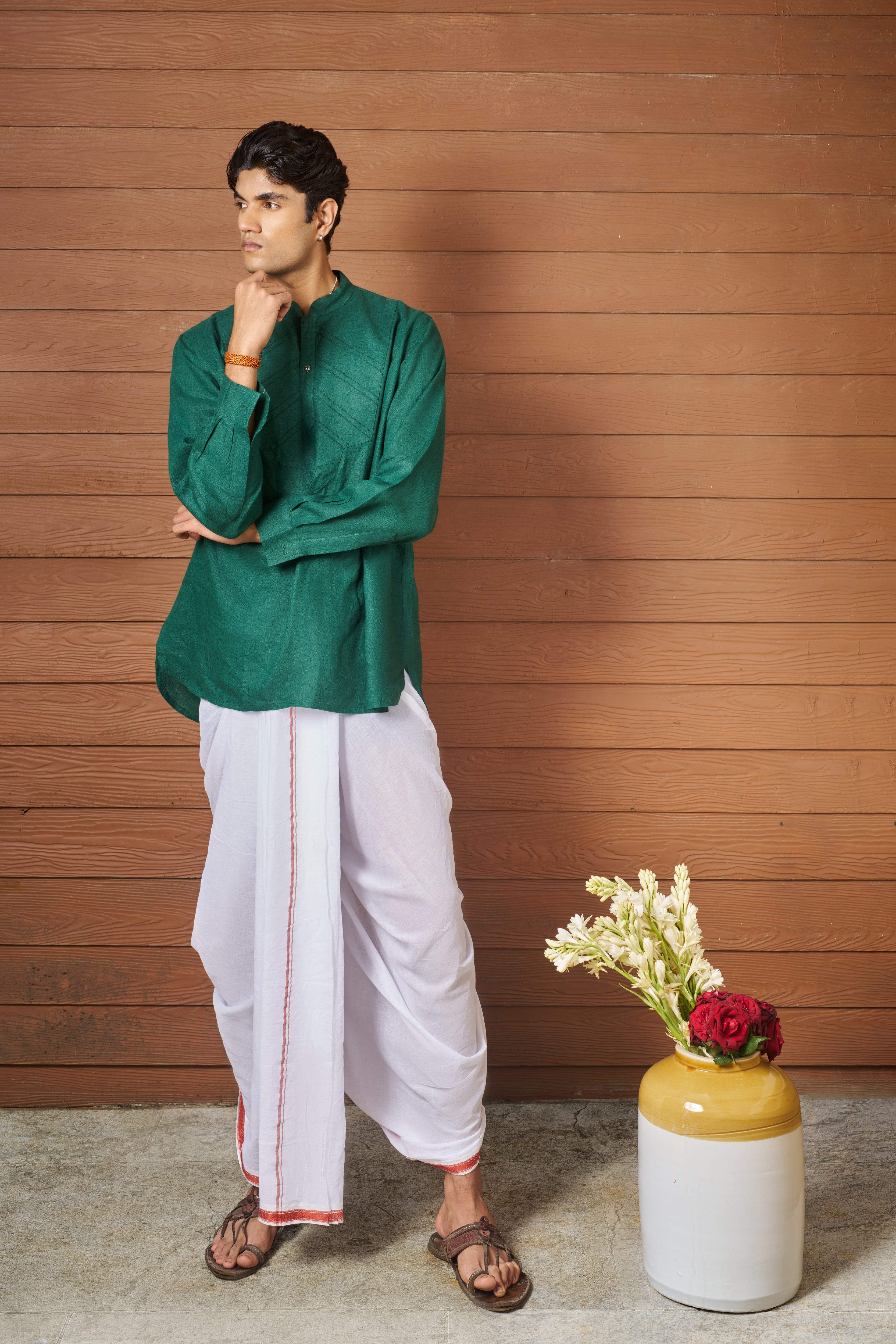 Man wearing a green shirt and white pants, sustainable fashion brands for men,  minimal menswear brands India