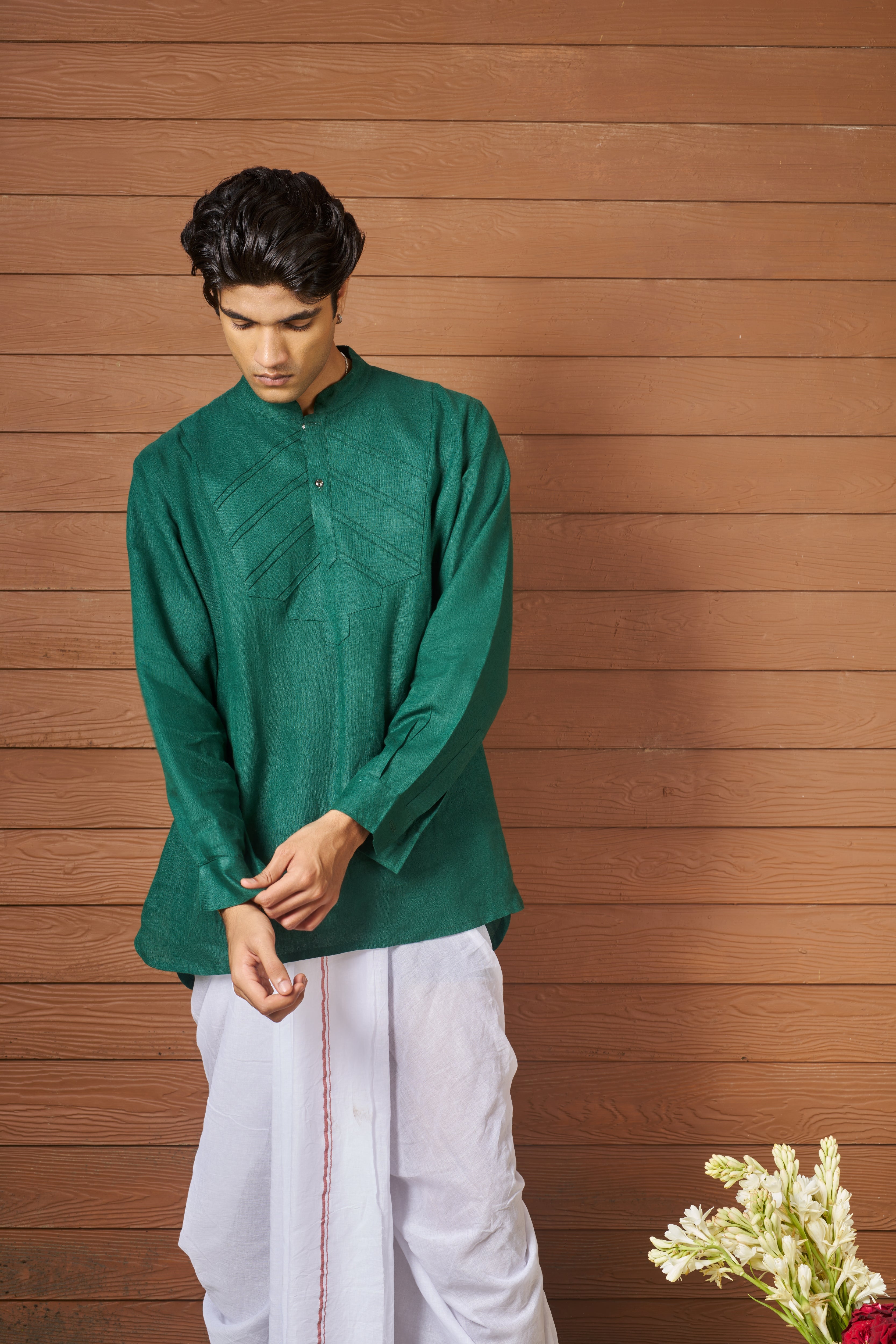 Man wearing a green shirt and white pants,  sustainable fashion brands for men,  minimal menswear brands India