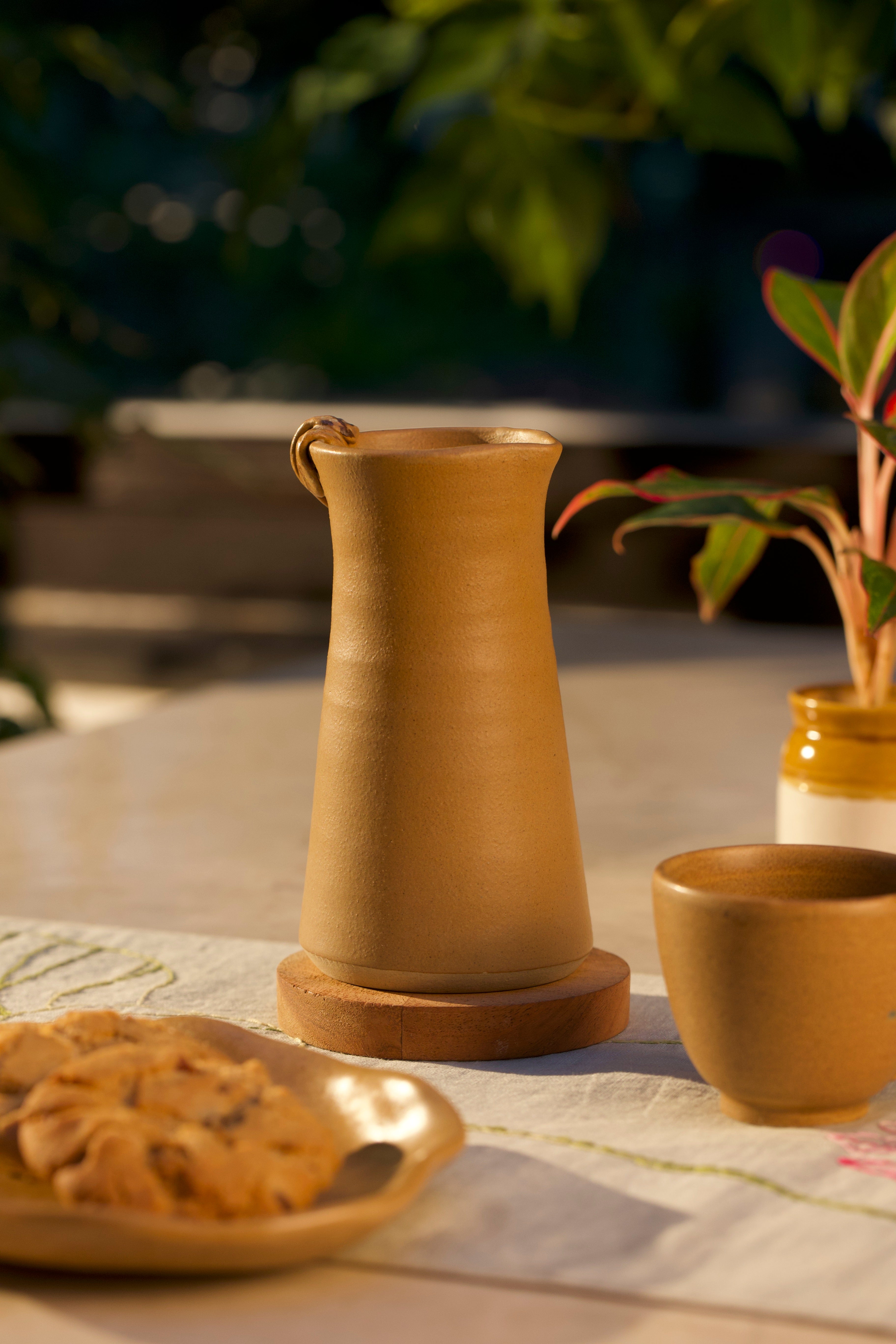  Mustard ceramic pitcher and cup on a table ceramic tableware India, pottery brands in India
