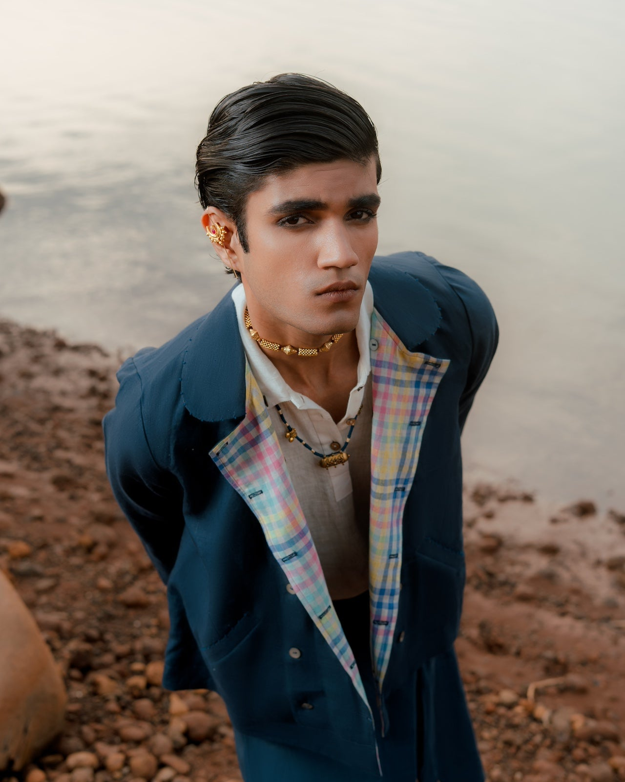 Man wearing a blue jacket with plaid accents,  slow fashion menswear,
 eco-friendly men’s clothing,
 breathable linen shirts India
