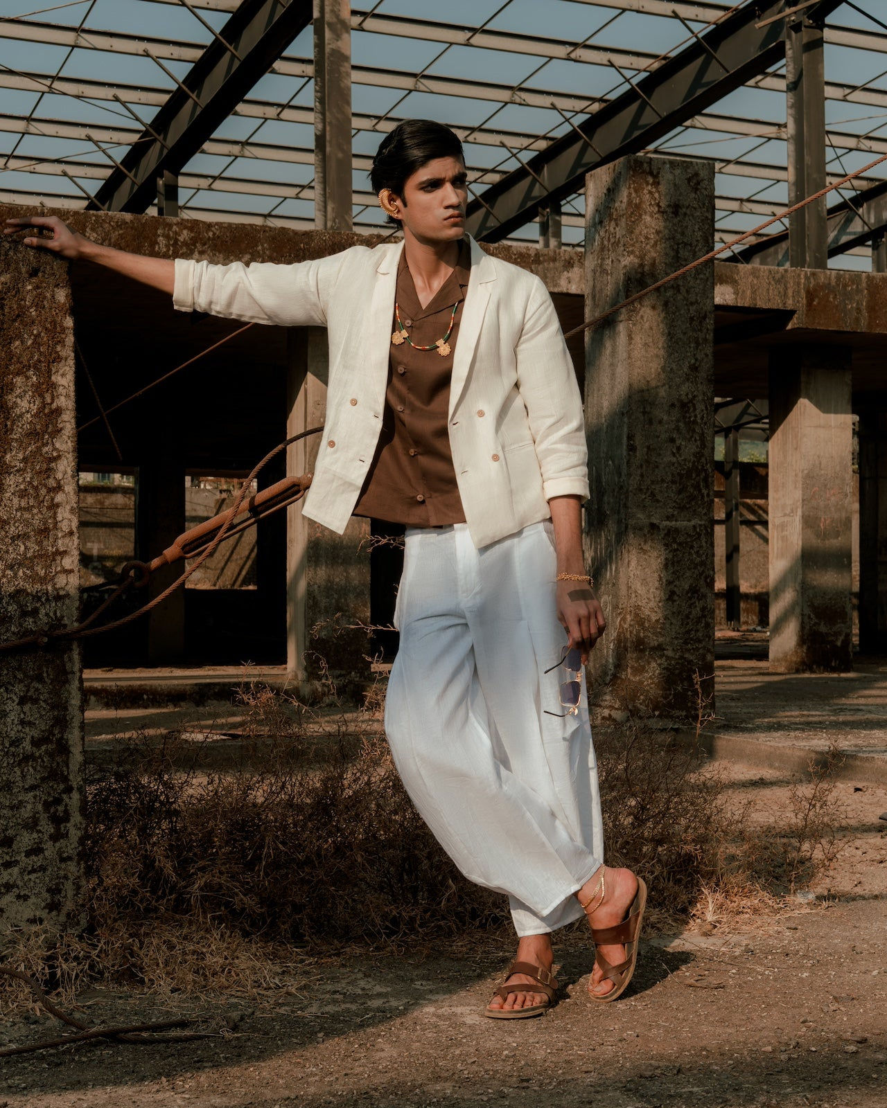 Person wearing a white jacket and light-colored pants,  minimal menswear brands India,
 conscious men’s style India,
 summer linen outfits for men

