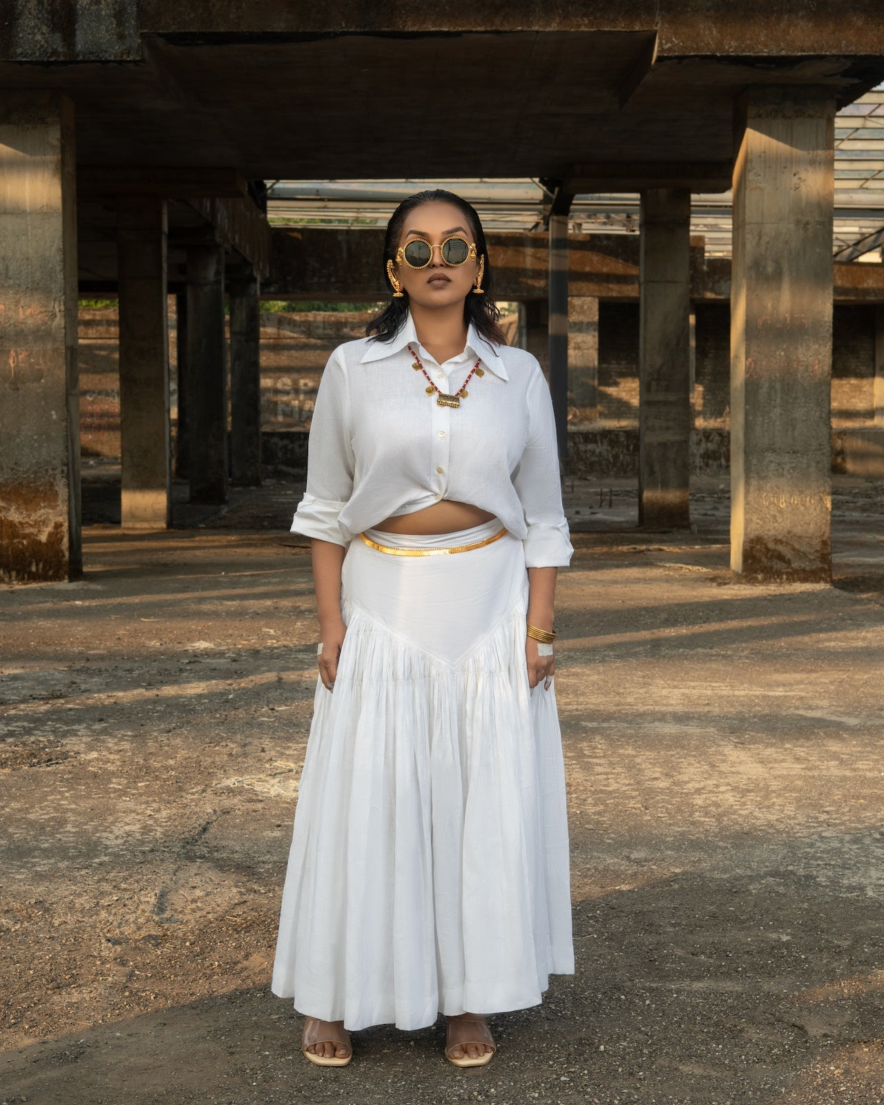 Woman in a white outfit standing under a bridge, Linen clothing mumbai,
Womens linen fashion shop online,
 women’s linen clothing India,
 100% linen clothes India
