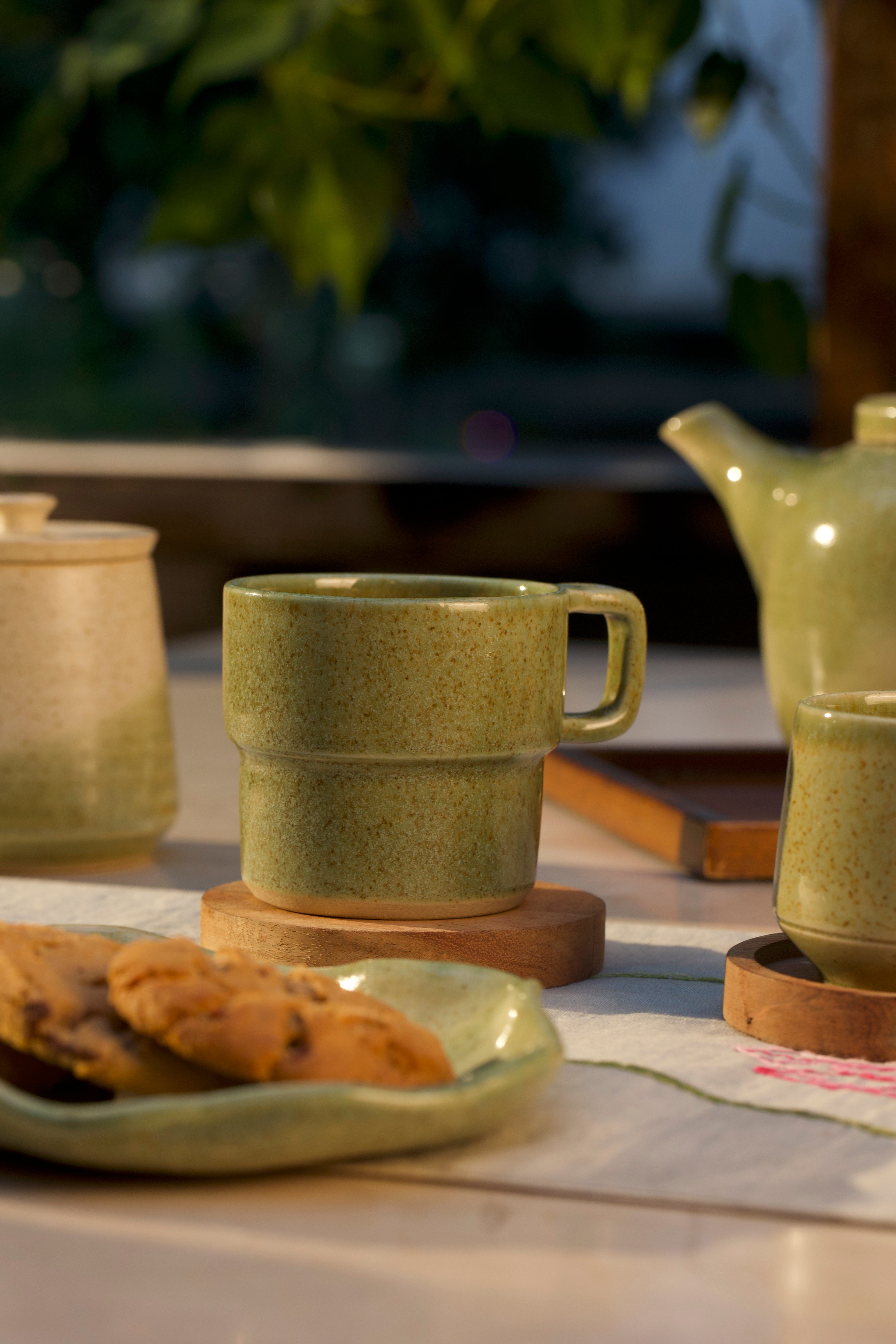 Green ceramic mug and teapot on a table, ceramic coffee mugs online,
Indian pottery brands online