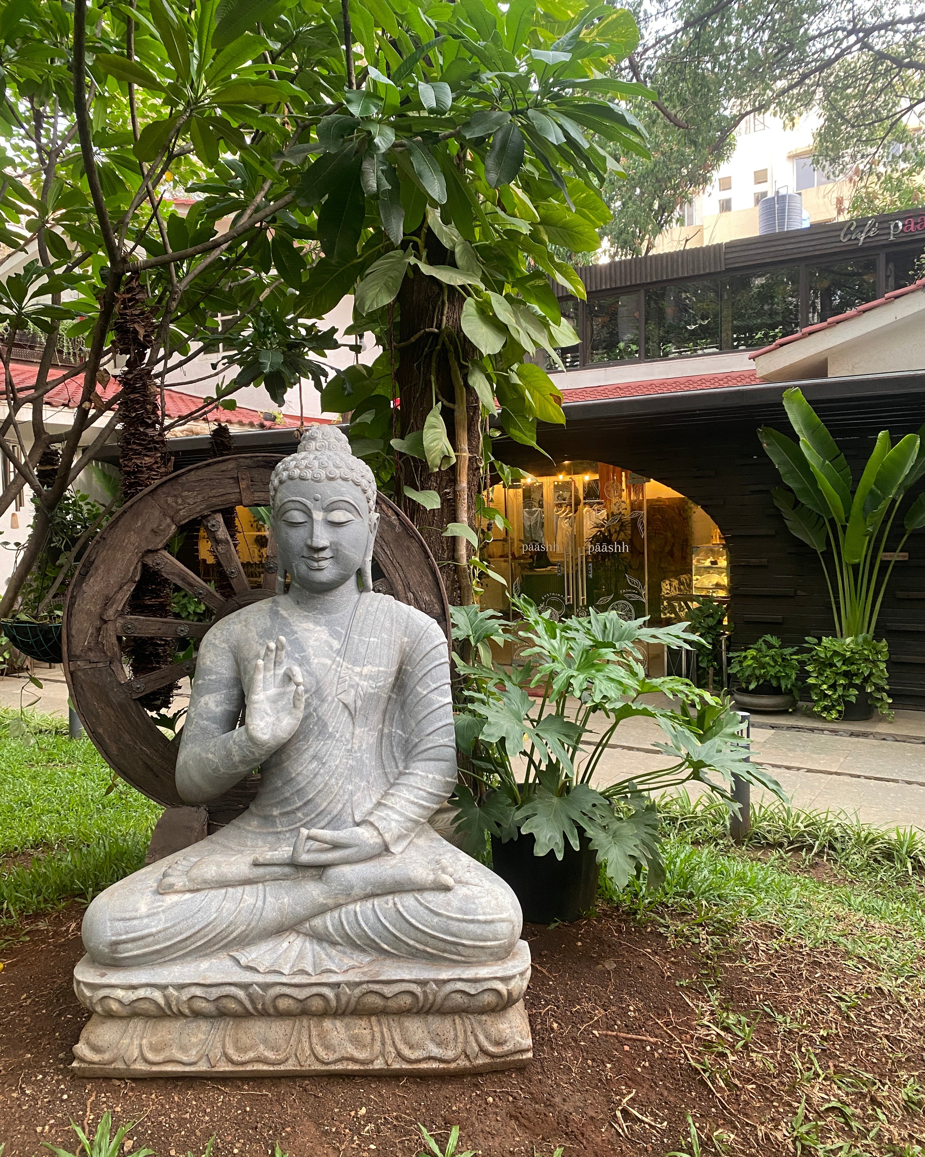 Stone statue of a meditating Buddha in paashh pune,  eco-friendly home décor stores,
 handcrafted linen clothing India,
 sustainable brands inspired by Indian culture