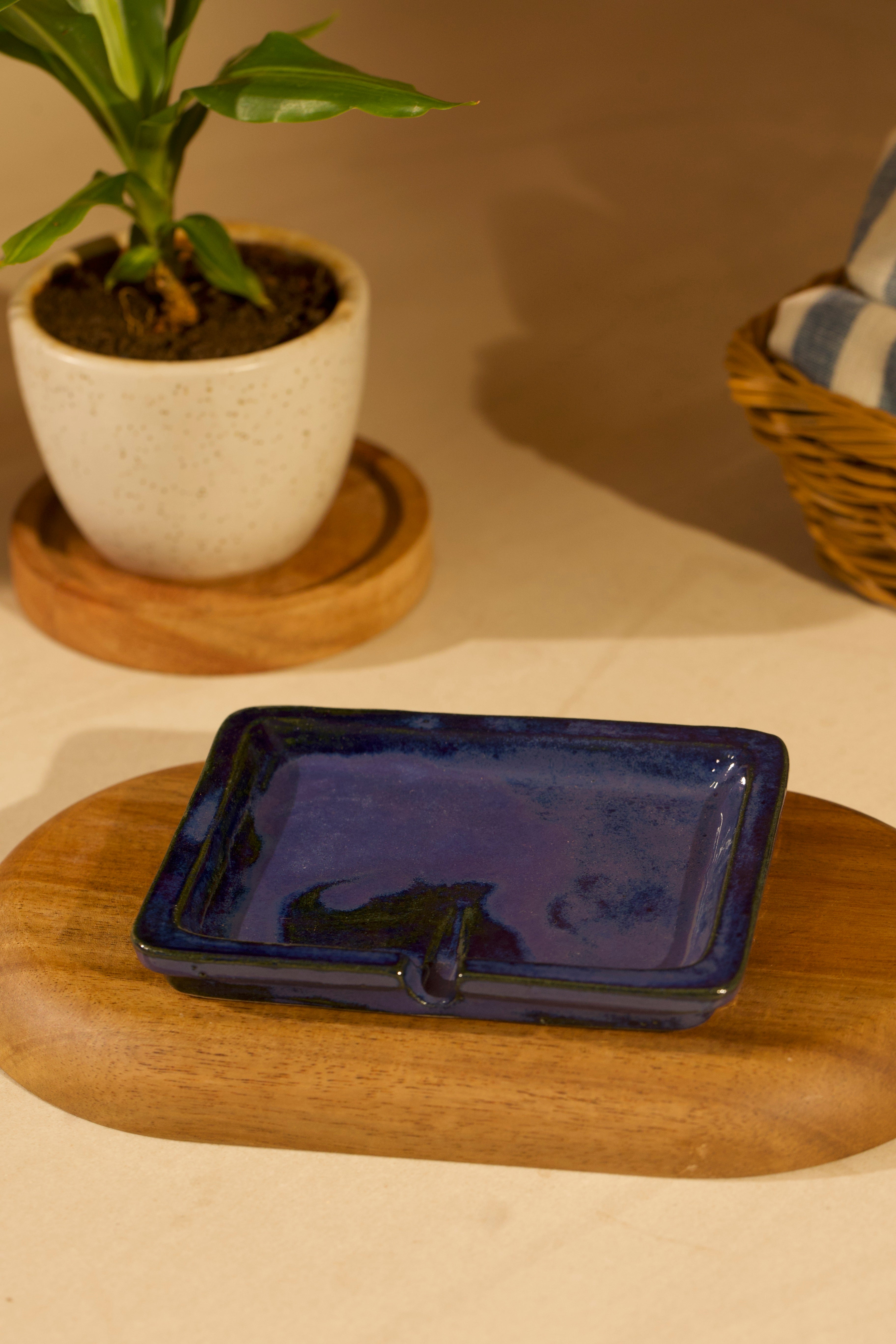Blue ceramic dish on a wooden surface.ceramic home décor online, pottery home decor