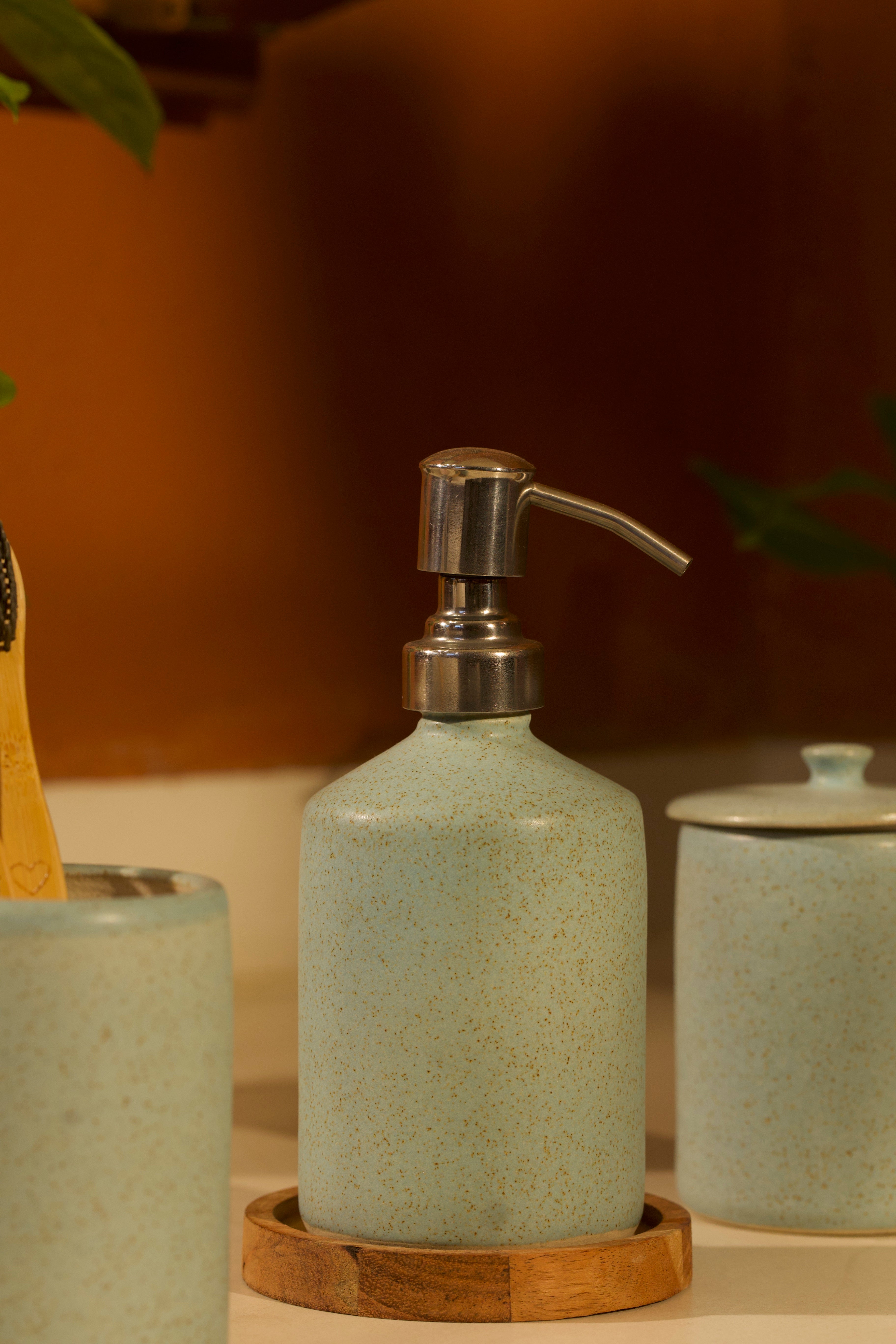 Green ceramic soap dispenser with pump on a wooden tray,  ceramic home décor online, pottery home decor
