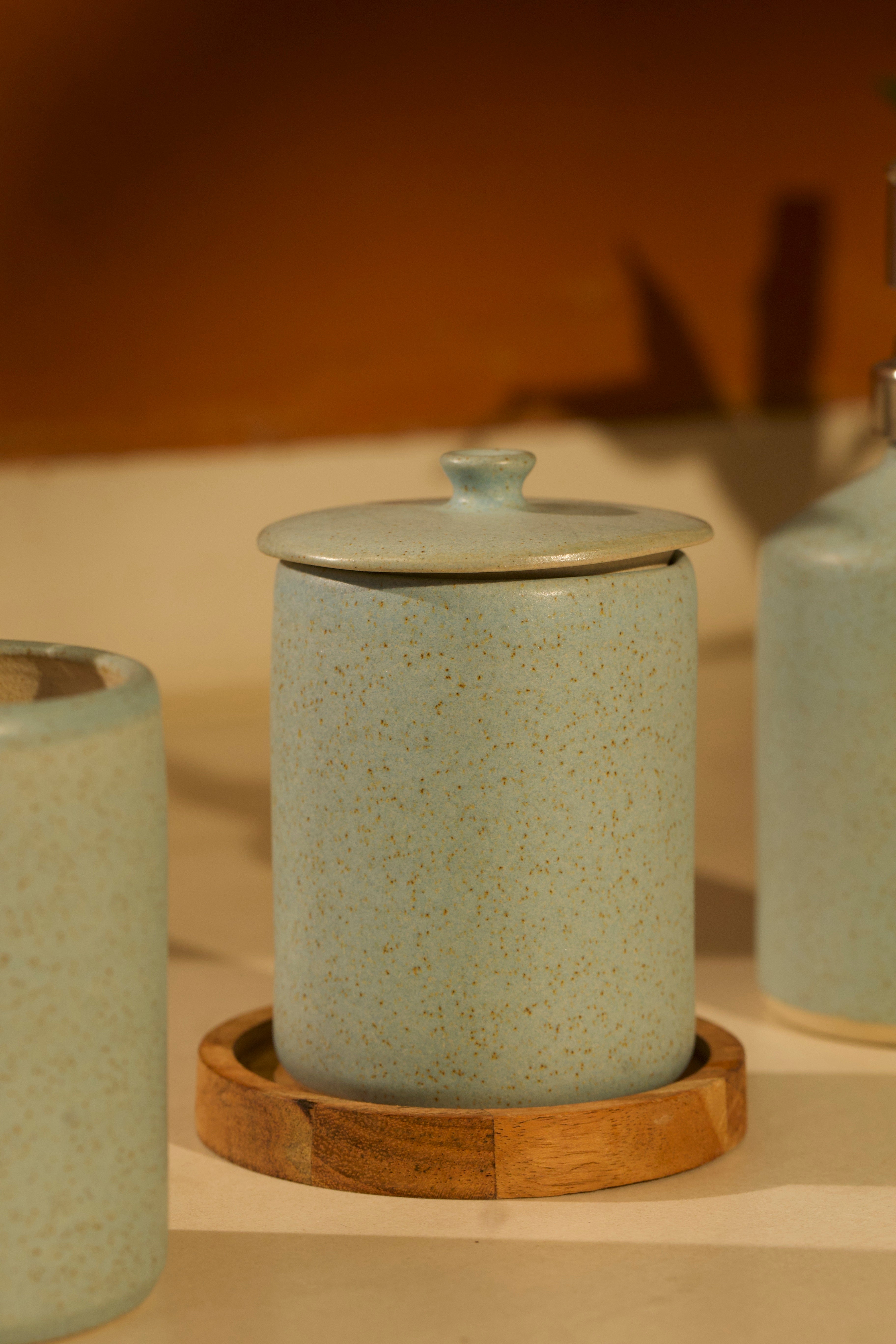 Ceramic jar with a lid on a wooden coaster  ceramic home décor online, pottery home decor
