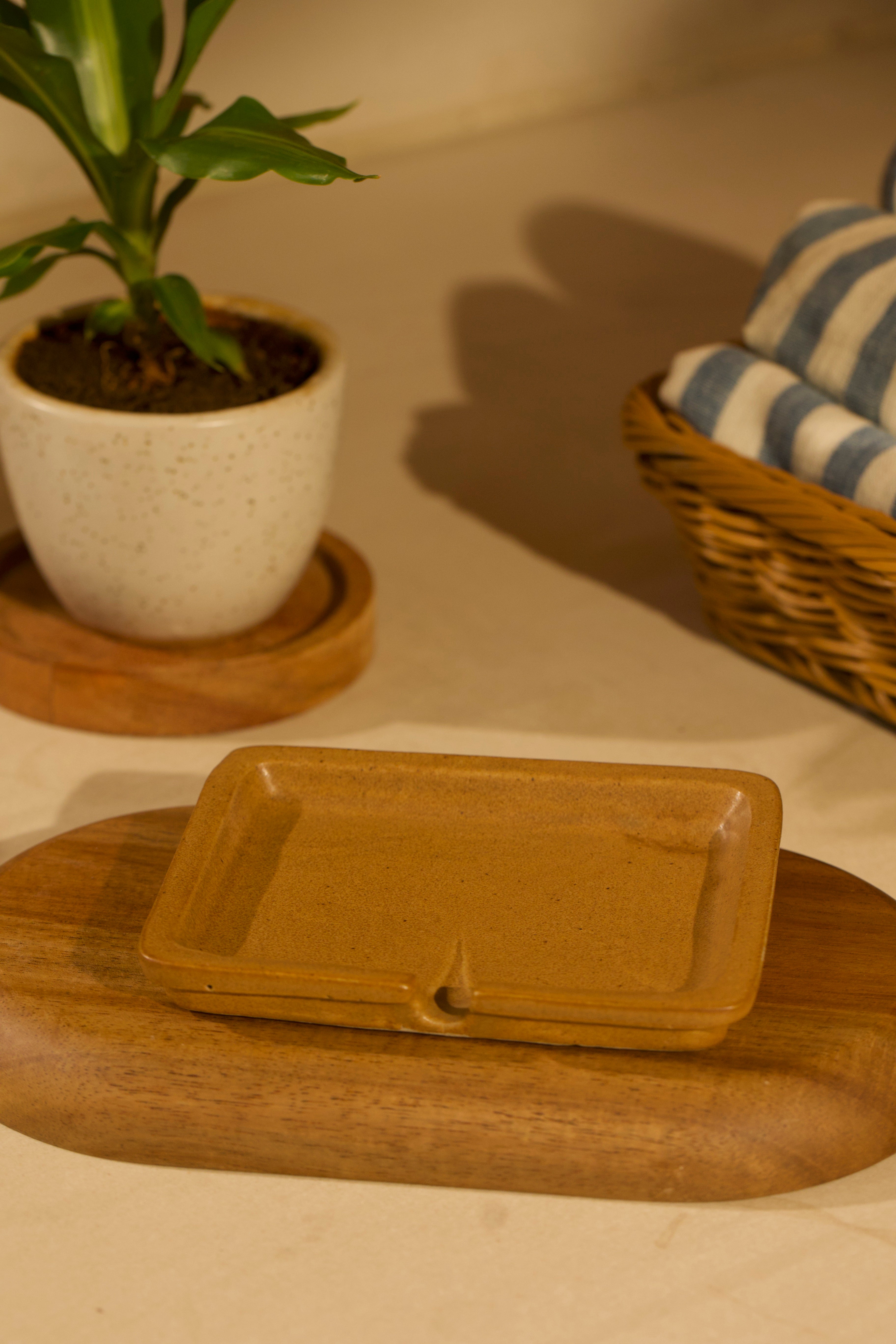 Green ceramic dish on a wooden surface. ceramic home décor online, pottery home decor