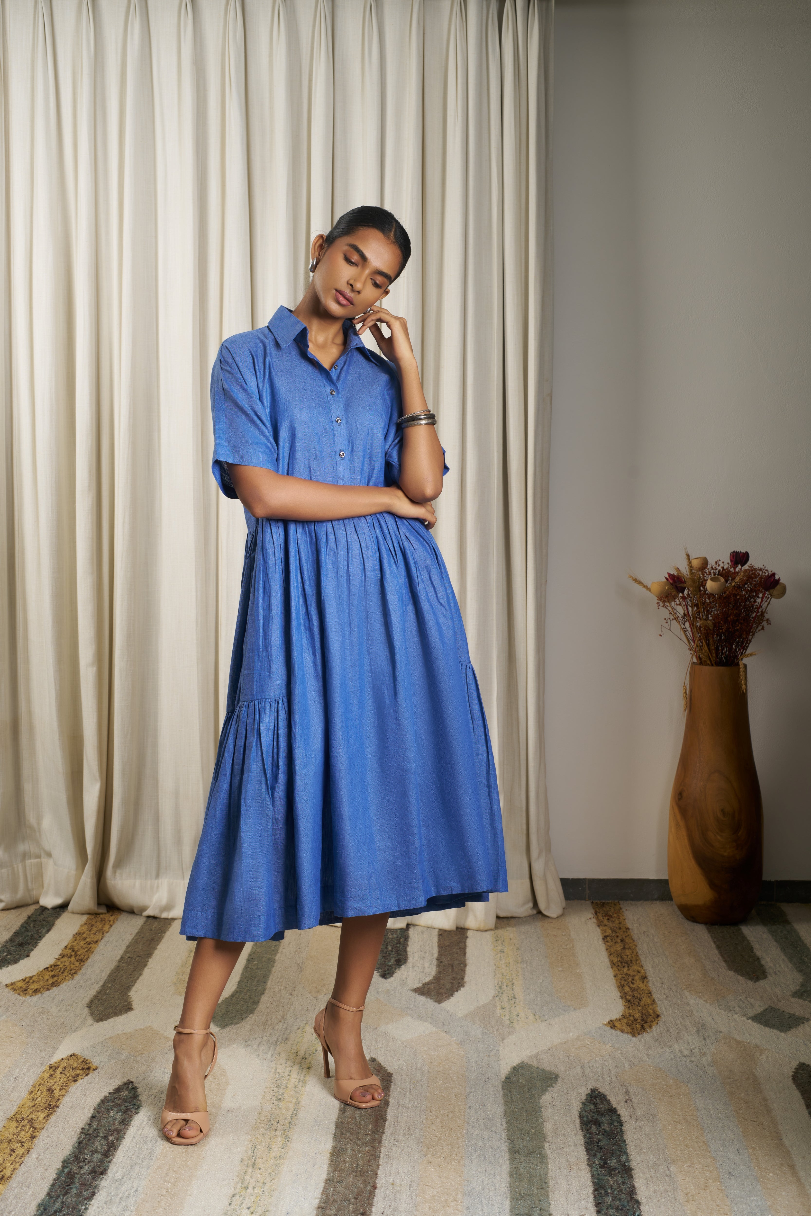 Woman wearing a blue dress. linen dresses for women India, minimalist clothing brands India