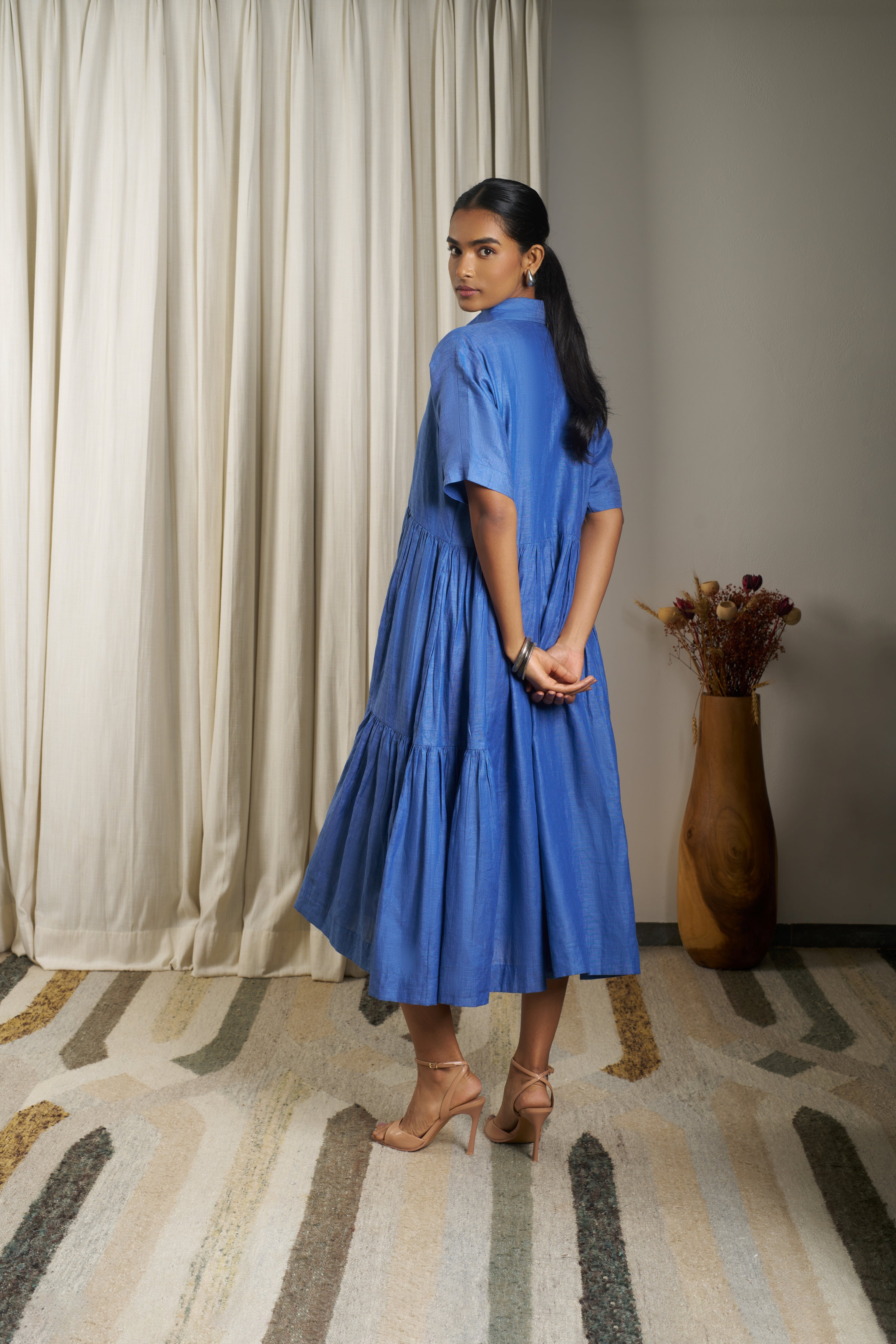 Woman wearing a blue dress. linen dresses for women India, minimalist clothing brands India