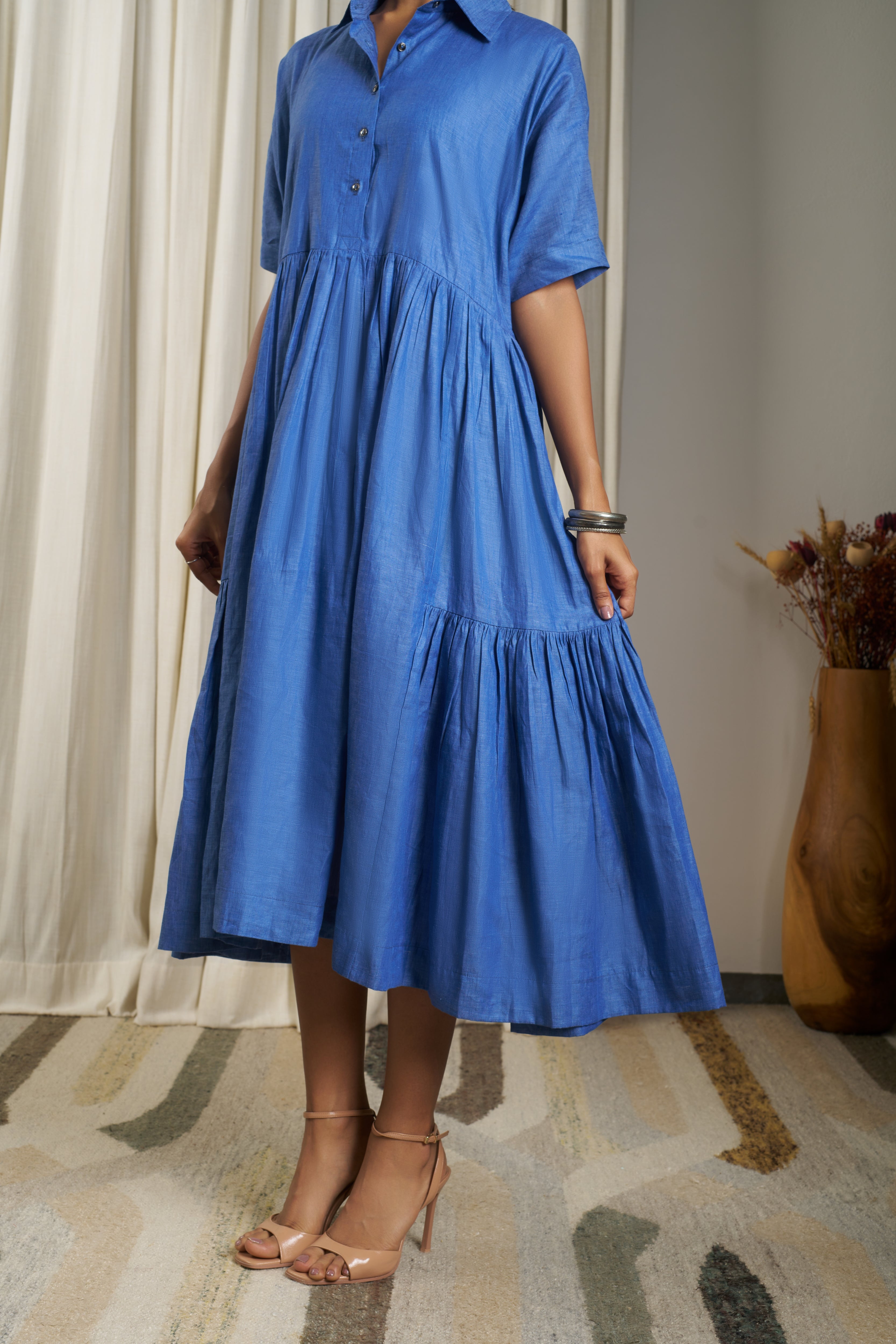 Woman wearing a blue dress. linen dresses for women India, minimalist clothing brands India