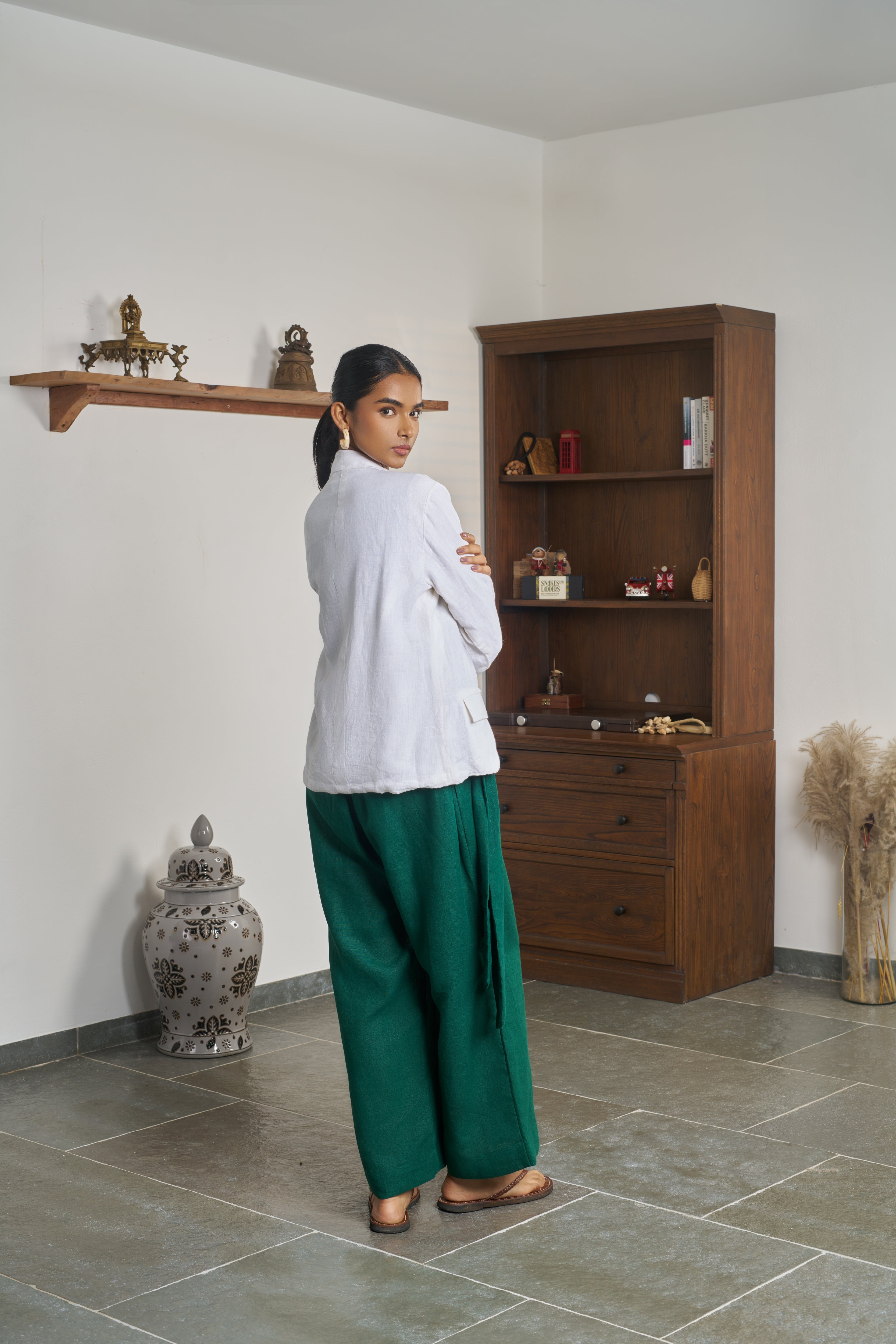 Woman wearing a white shirt and green pants. ethical clothing brands for women,  minimalist clothing brands India
