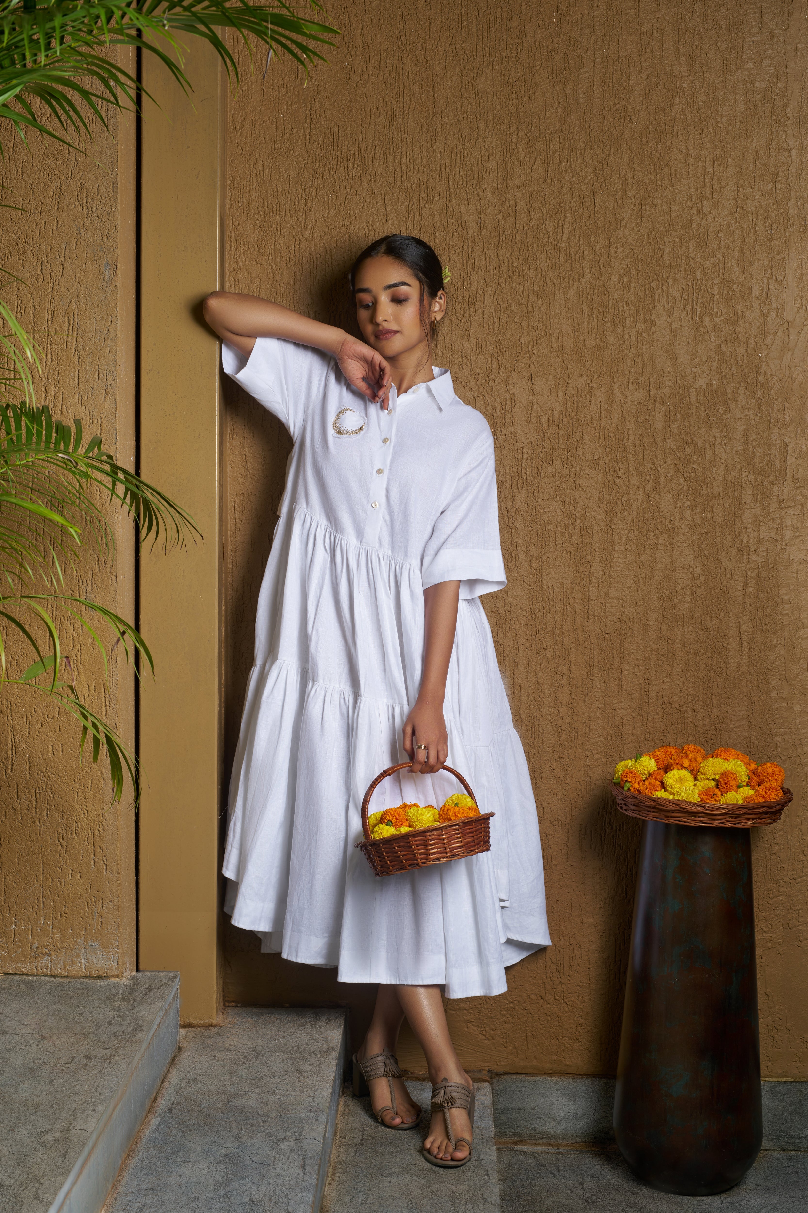Woman wearing a white dress with a moon embroidery. comfortable linen dresses India, Casual linen fashion
