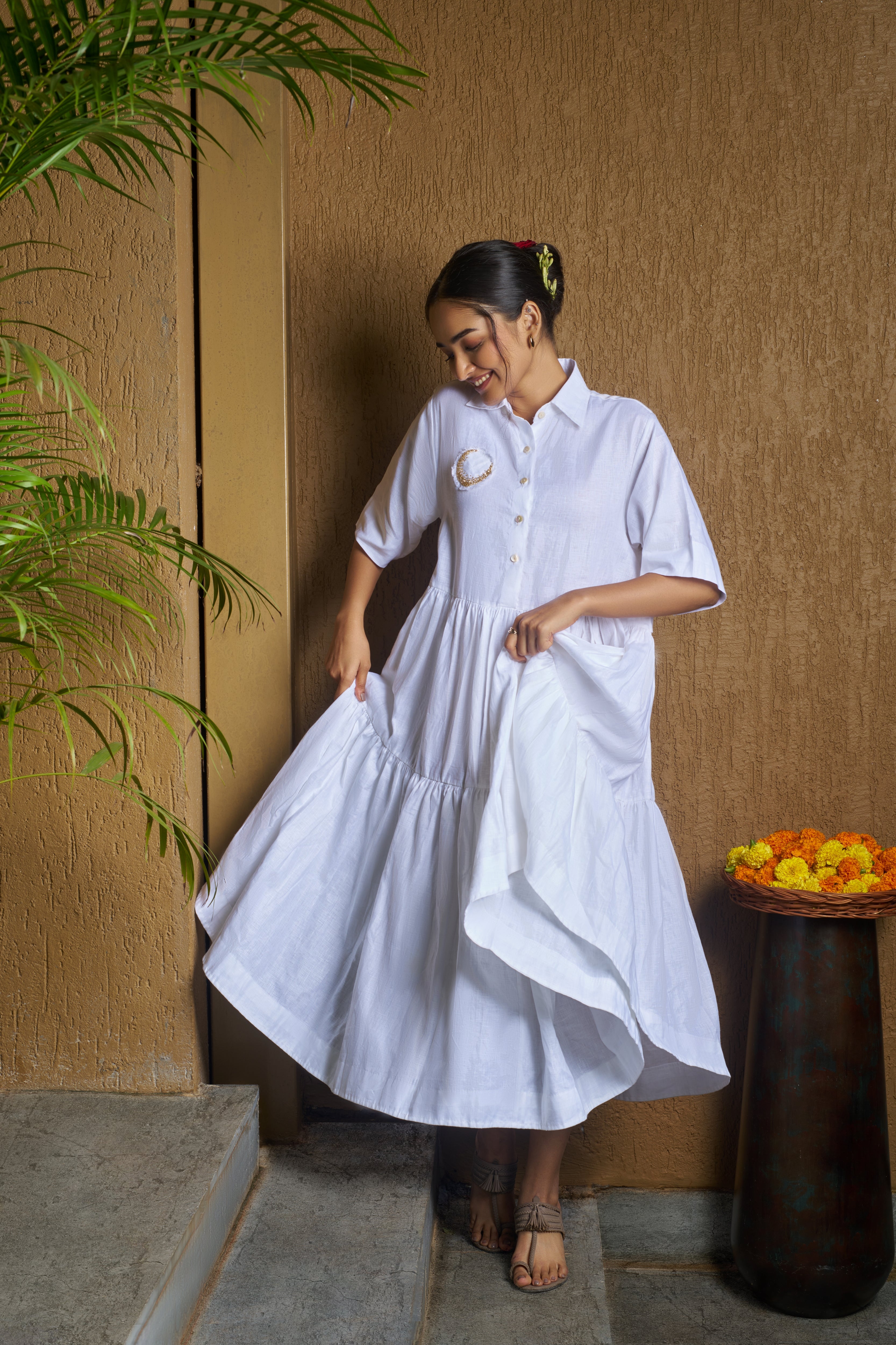 Woman wearing a white dress with a moon embroidery. comfortable linen dresses India, Casual linen fashion
