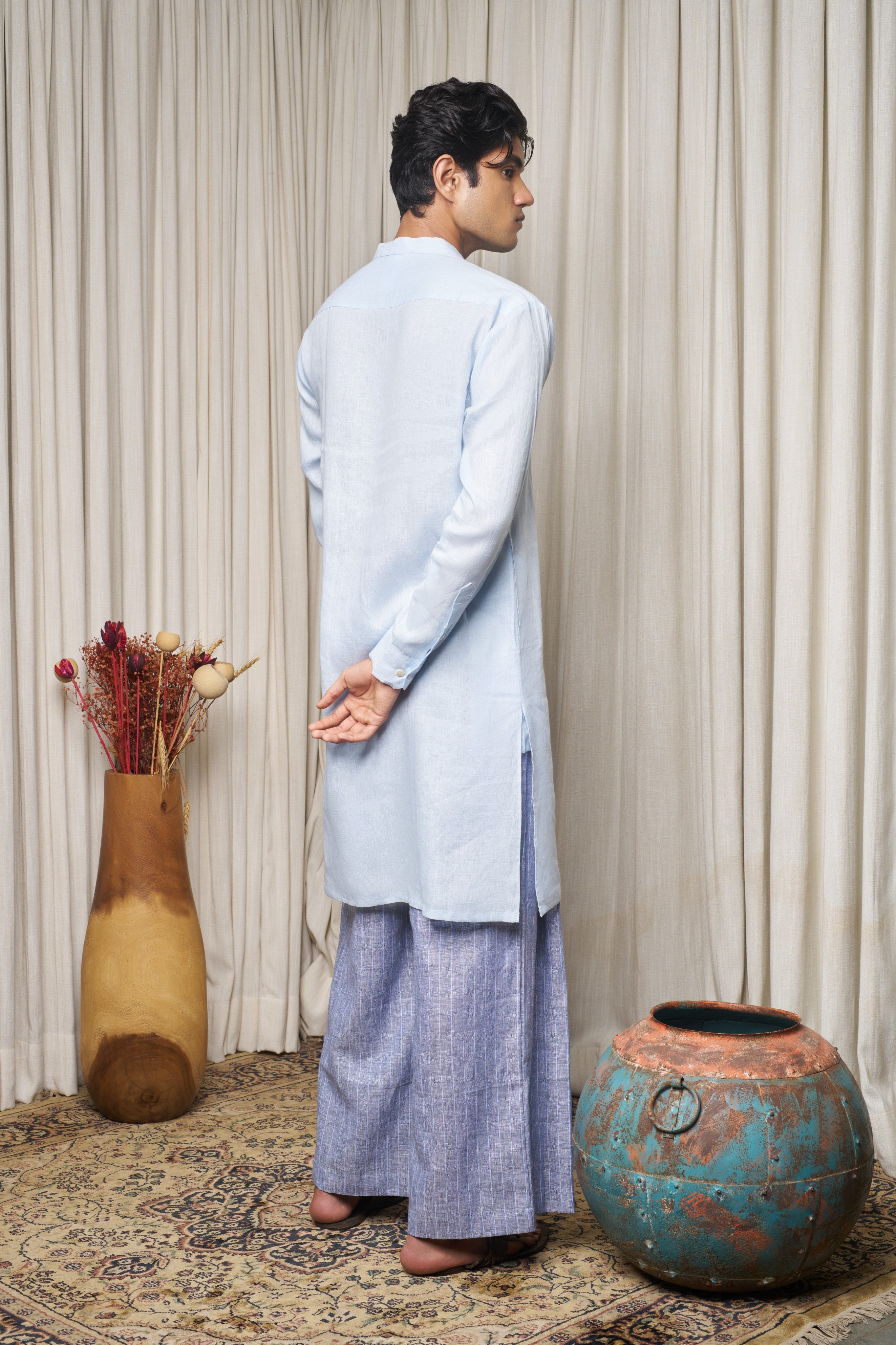 Man wearing a white traditional outfit. ethical men’s fashion India, slow fashion menswear