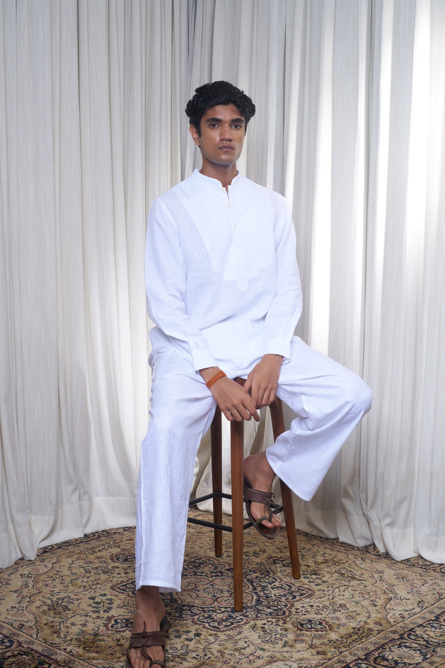 Man in a white traditional outfit, sustainable fashion brands for men, minimal menswear brands India